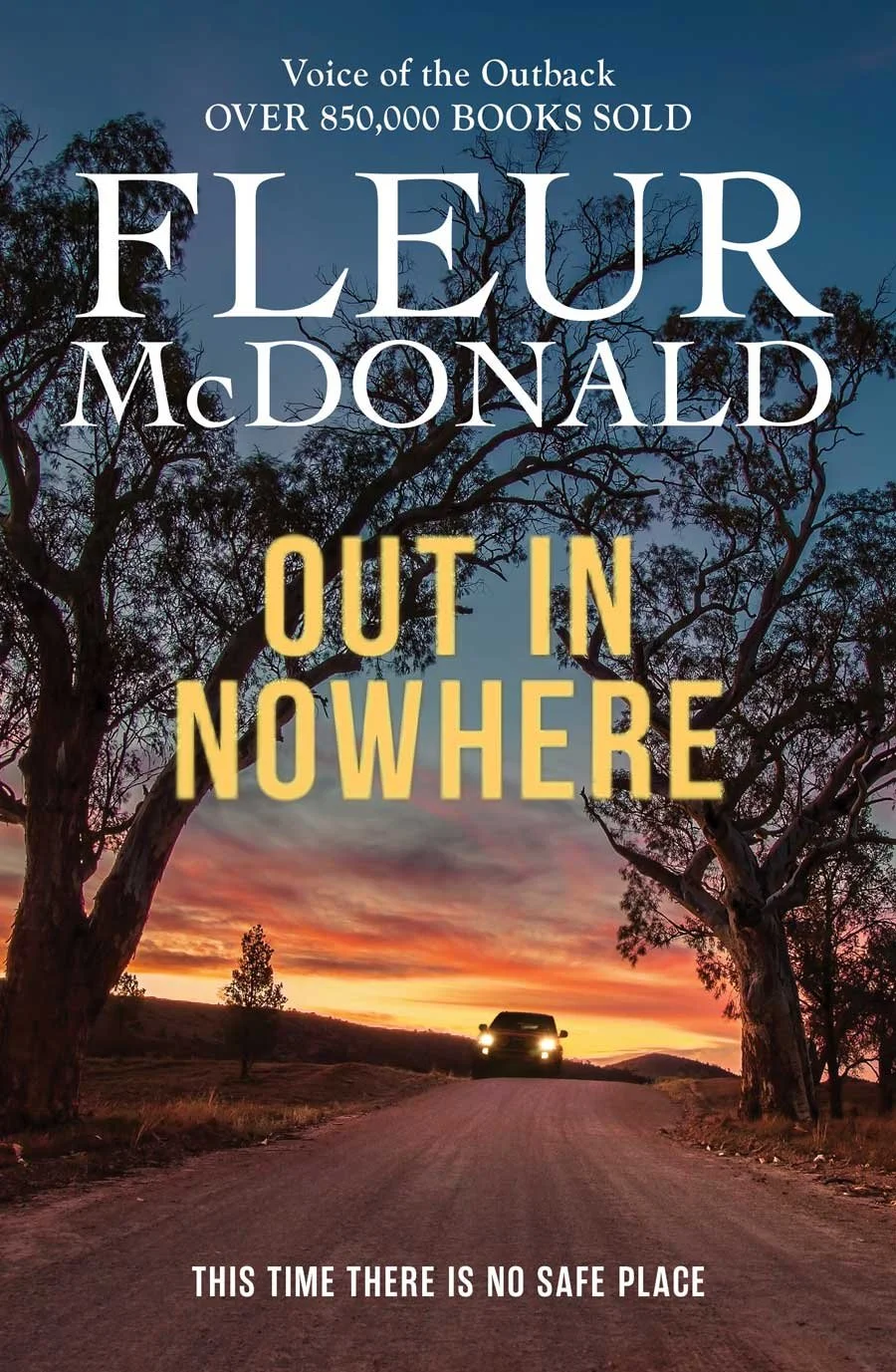 Cover of a book titled "Out in Nowhere," by Fleur McDonald, with a subtitle "Voice of the Outback, Over 850,000 Books Sold." The cover shows a rural dirt road at sunset, with a car approaching in the distance, flanked by large trees and a colorful sk