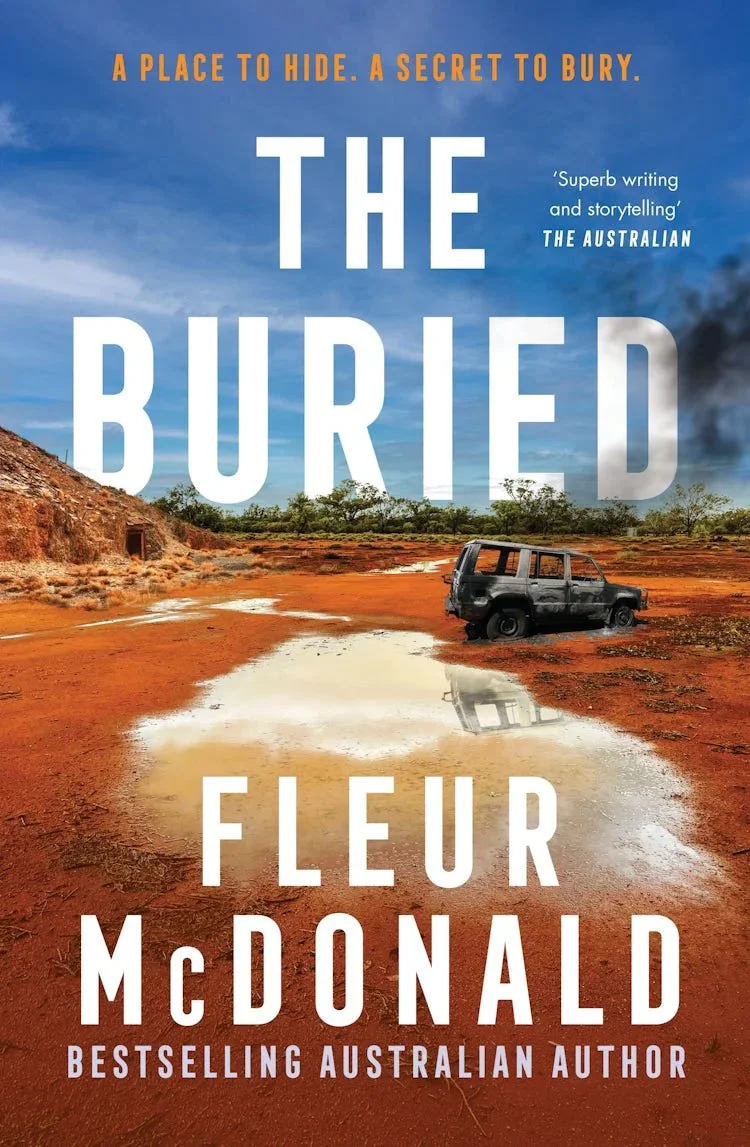 Book cover for The Buried by Fleur McDonald. Image: A burnt out four-wheel drive, sits forgotten and stuck in the red dust of the Kalgoorlie. A large puddle of water sits nearby. Text: A place to hide. A secret to bury.