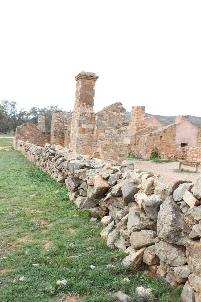 An old wall made of stones and broken down town made of stone
