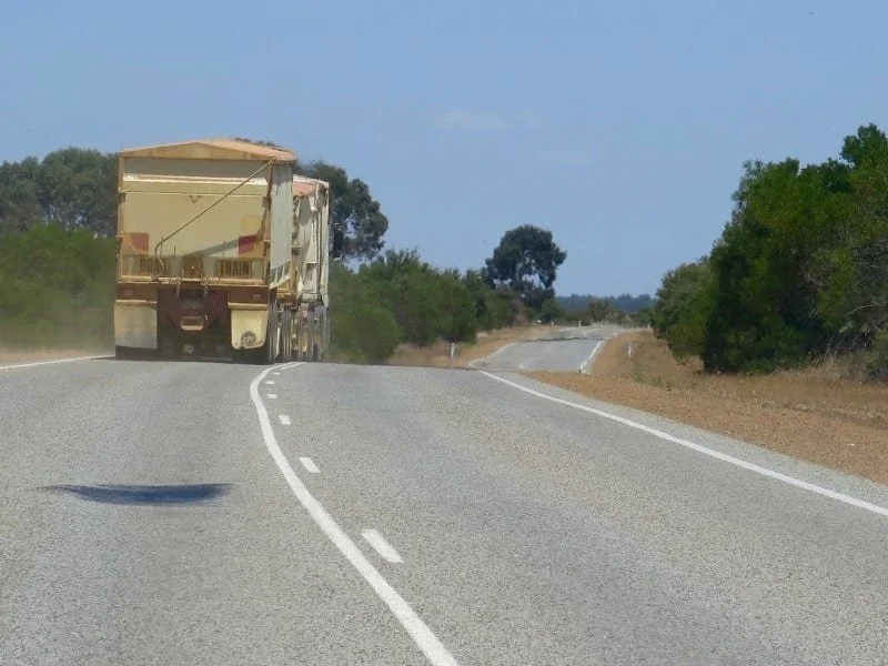 A truck moving a long a road