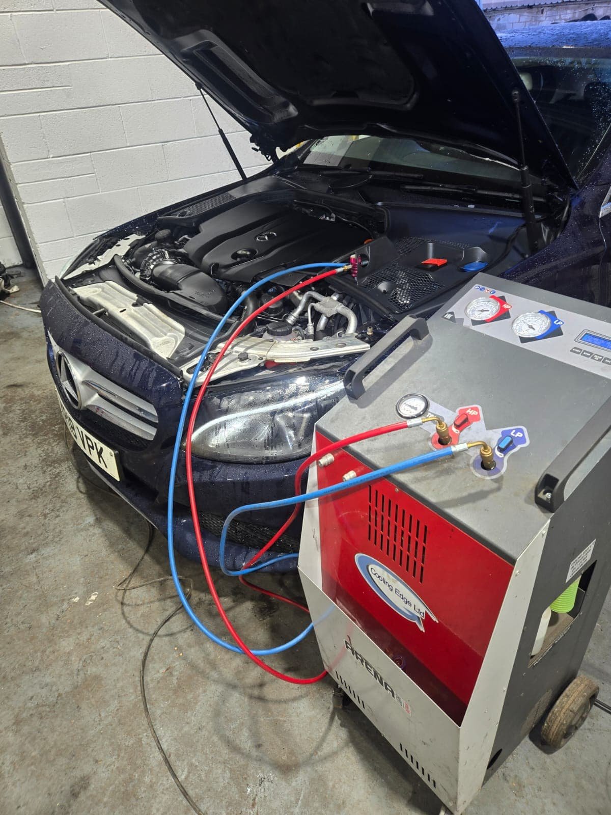 Car air conditioning regas service being carried out in Derby garage