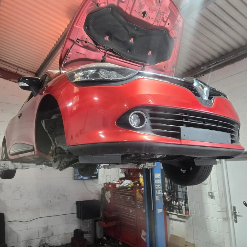 Car raised on a garage lift during vehicle repair