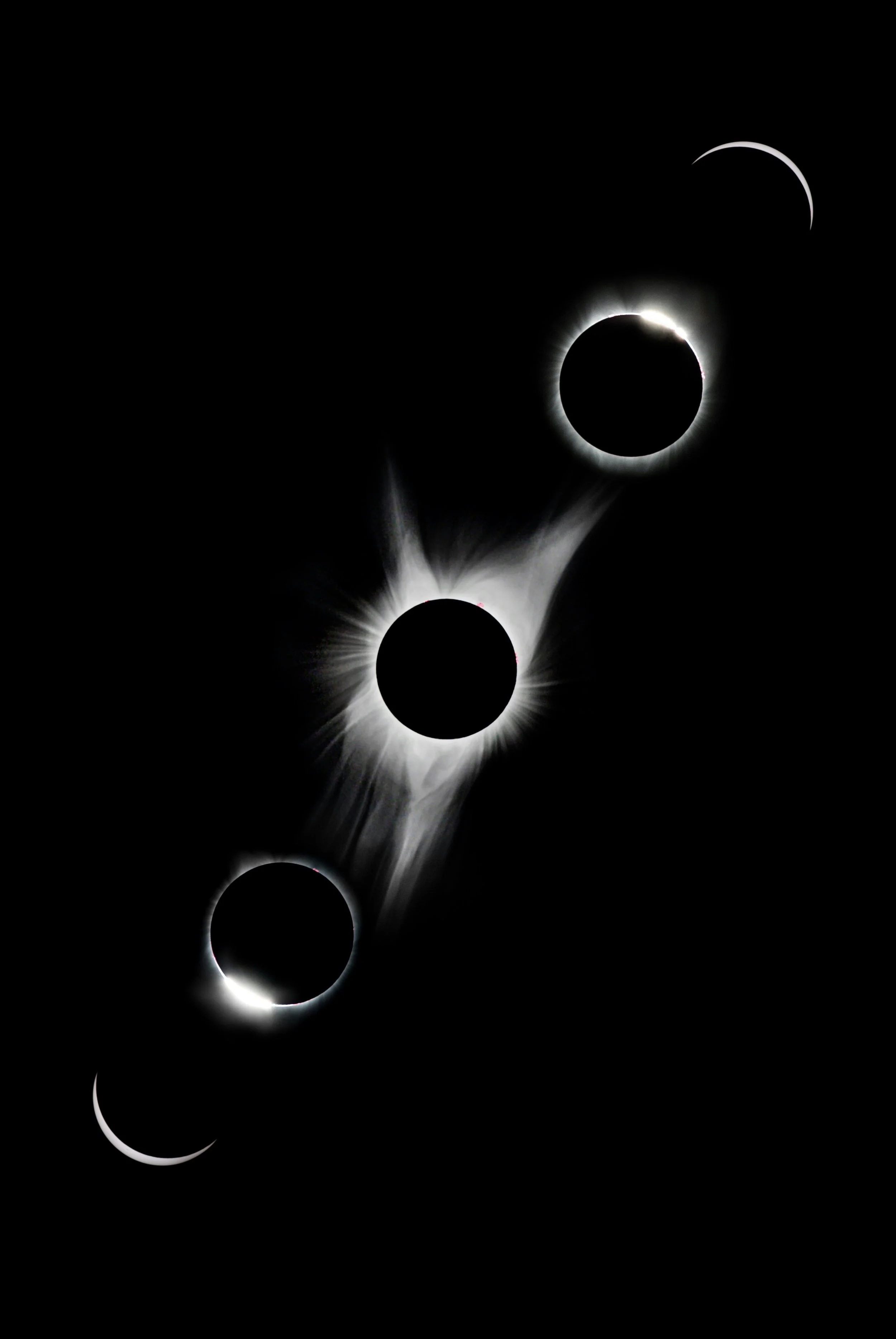 Luminous black planets aligned on a dark background.