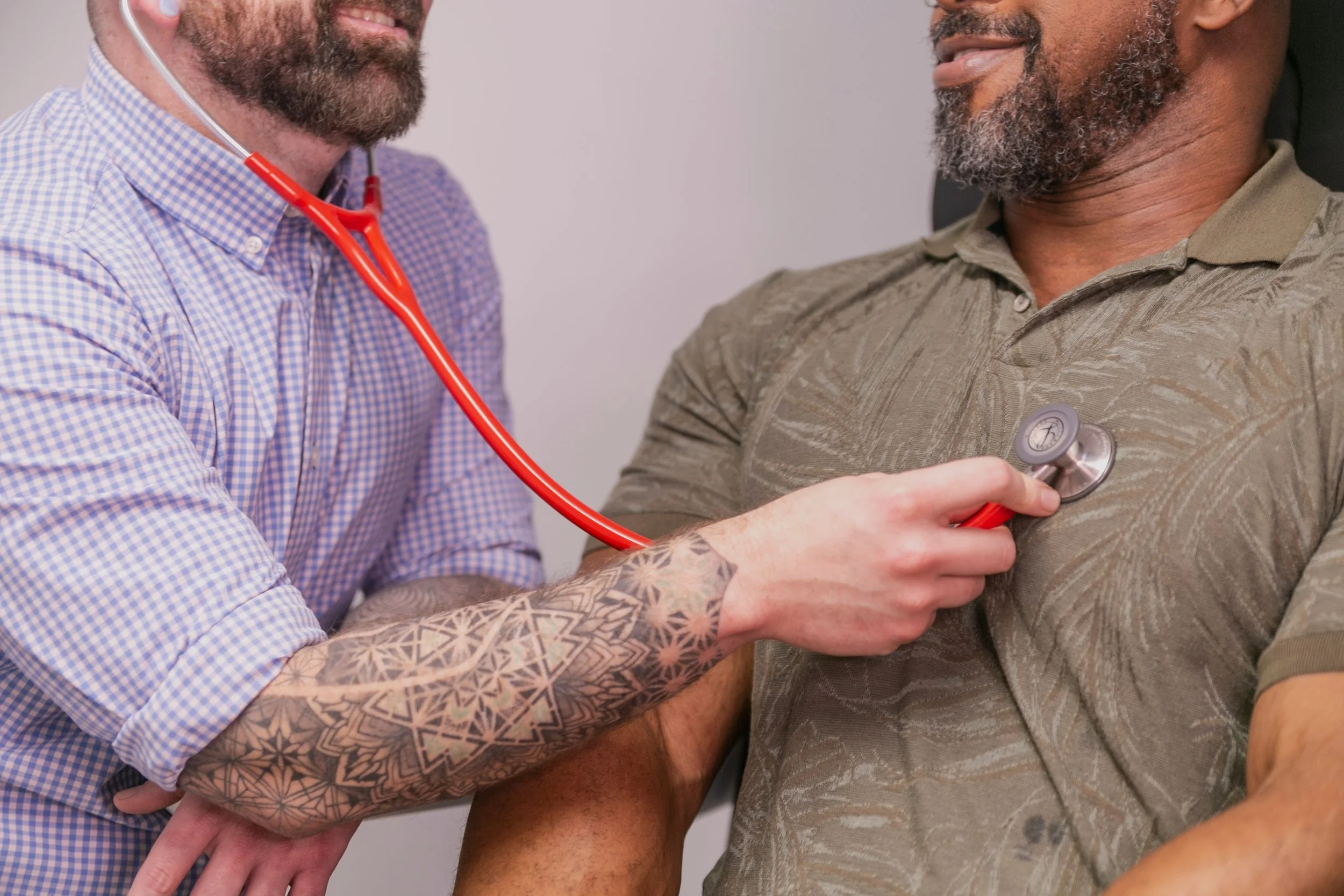 Primary care clinician performing a routine heart and lung exam during a medical visit.