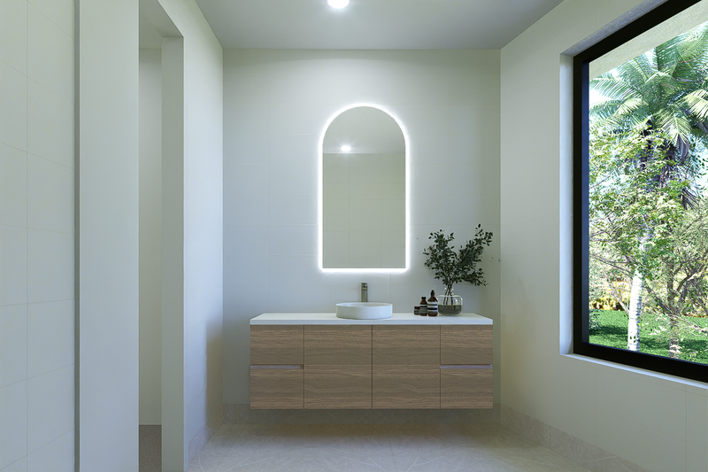 Modern bathroom with a floating wooden vanity, oval mirror with built-in lighting, white vessel sink, and large window showing green trees outside.