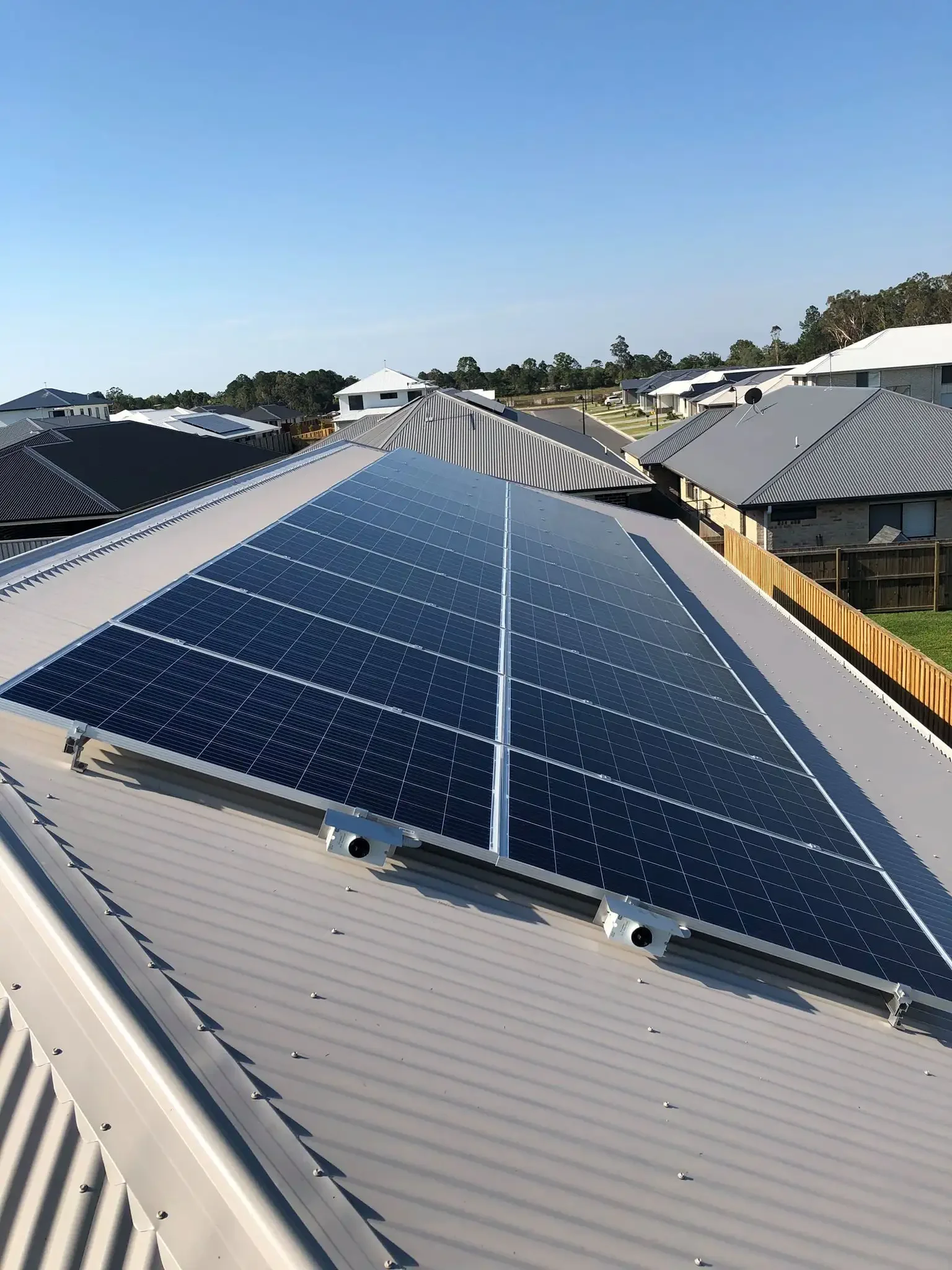 Solar panels installed on the roof of a house in a residential neighborhood.