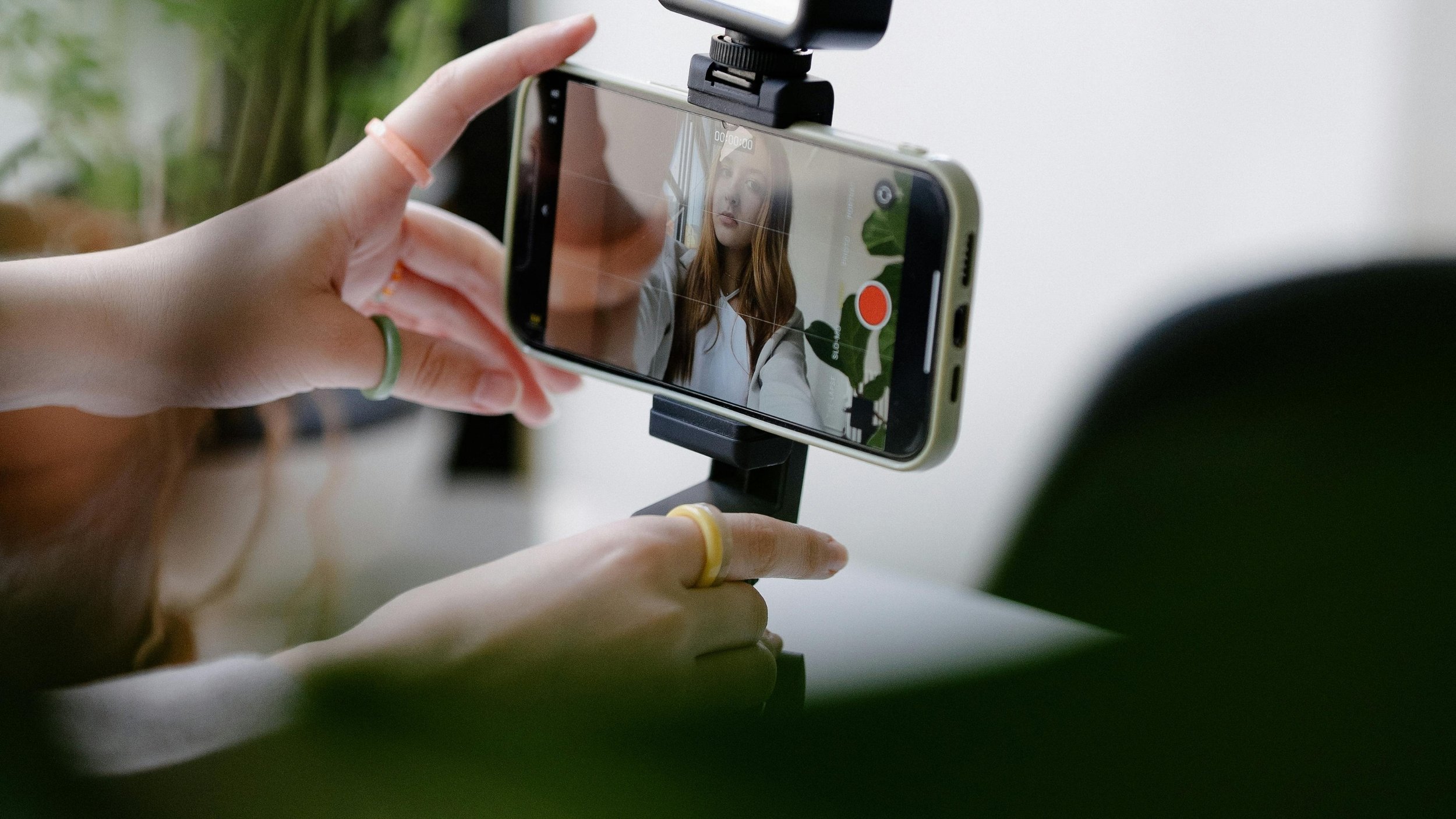 Creator filming a sponsored social media video on a smartphone mounted on a tripod, illustrating influencer content creation and the importance of vetting creators for authenticity and brand fit.