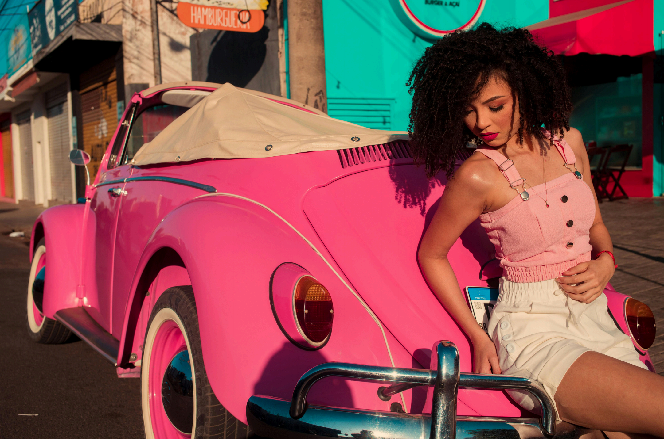 Influencer on a pink car, illustrating Instagram content creation and creative standard. Link Influence ensures precision targeting and placement optimization.