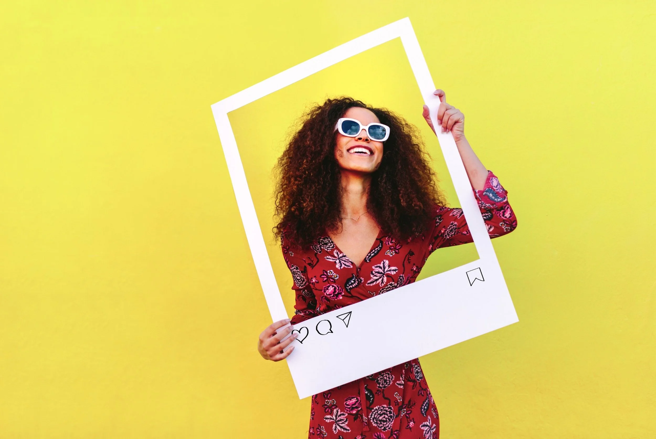 Woman holding an Instagram frame, symbolizing Influencer Marketing. Link Influence specializes in high-impact, social media influencer campaigns.