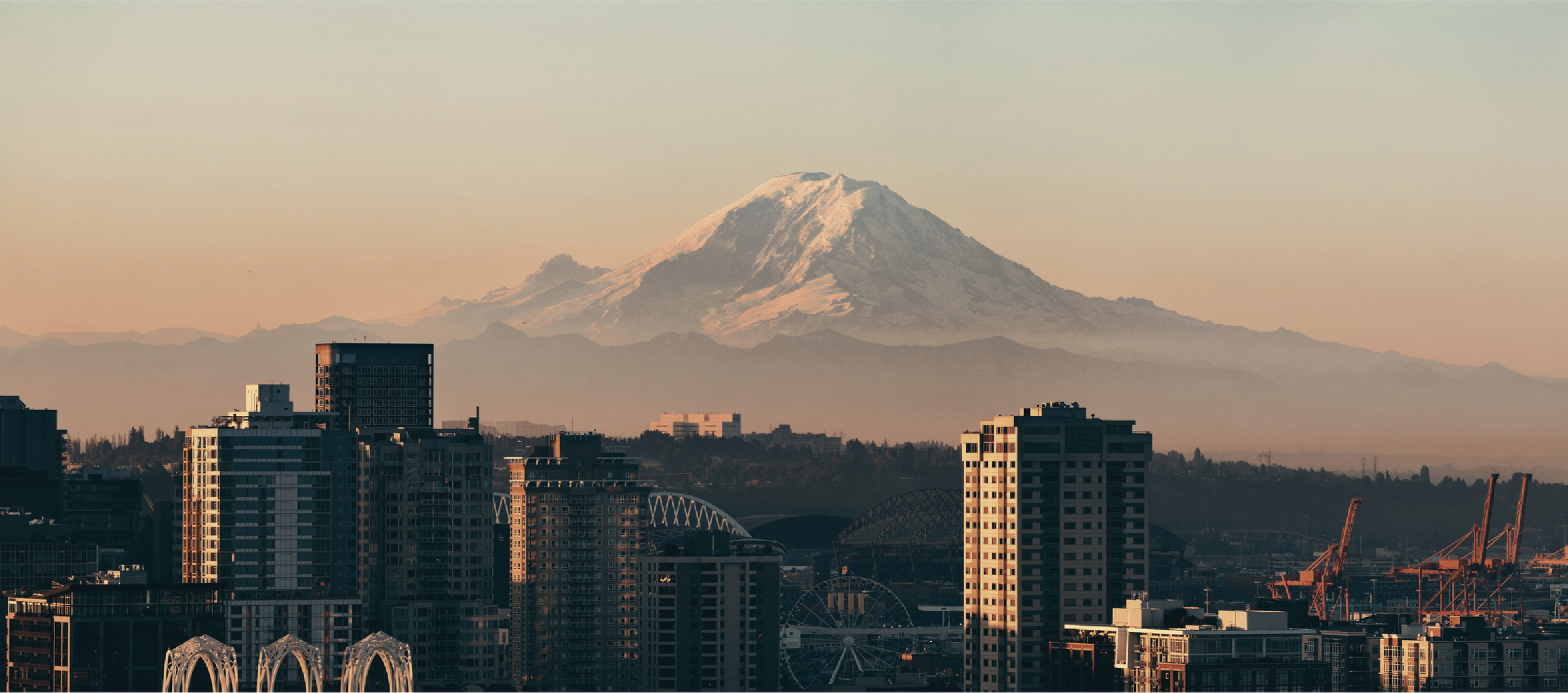 seattle influencer marketing agency, Mountain over city, illustrating Link Influence's philosophy. Influencer marketing is about resonance, not reach, driven by deep audience insight and creator selection.