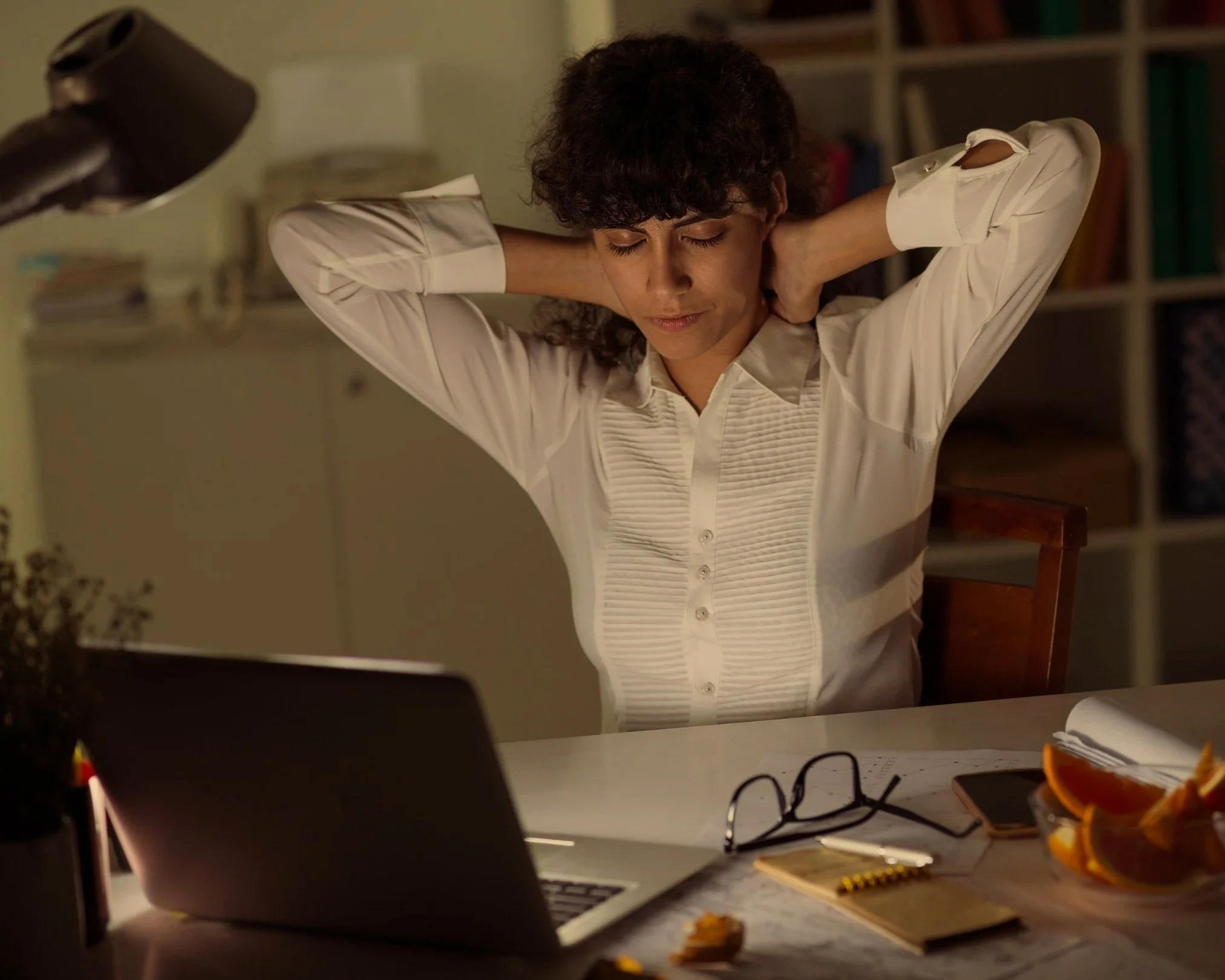Woman stretching at a desk, illustrating a real stories of relief campaign. Link Influence uses authentic storytelling and real-world scenarios to highlight product benefits.
