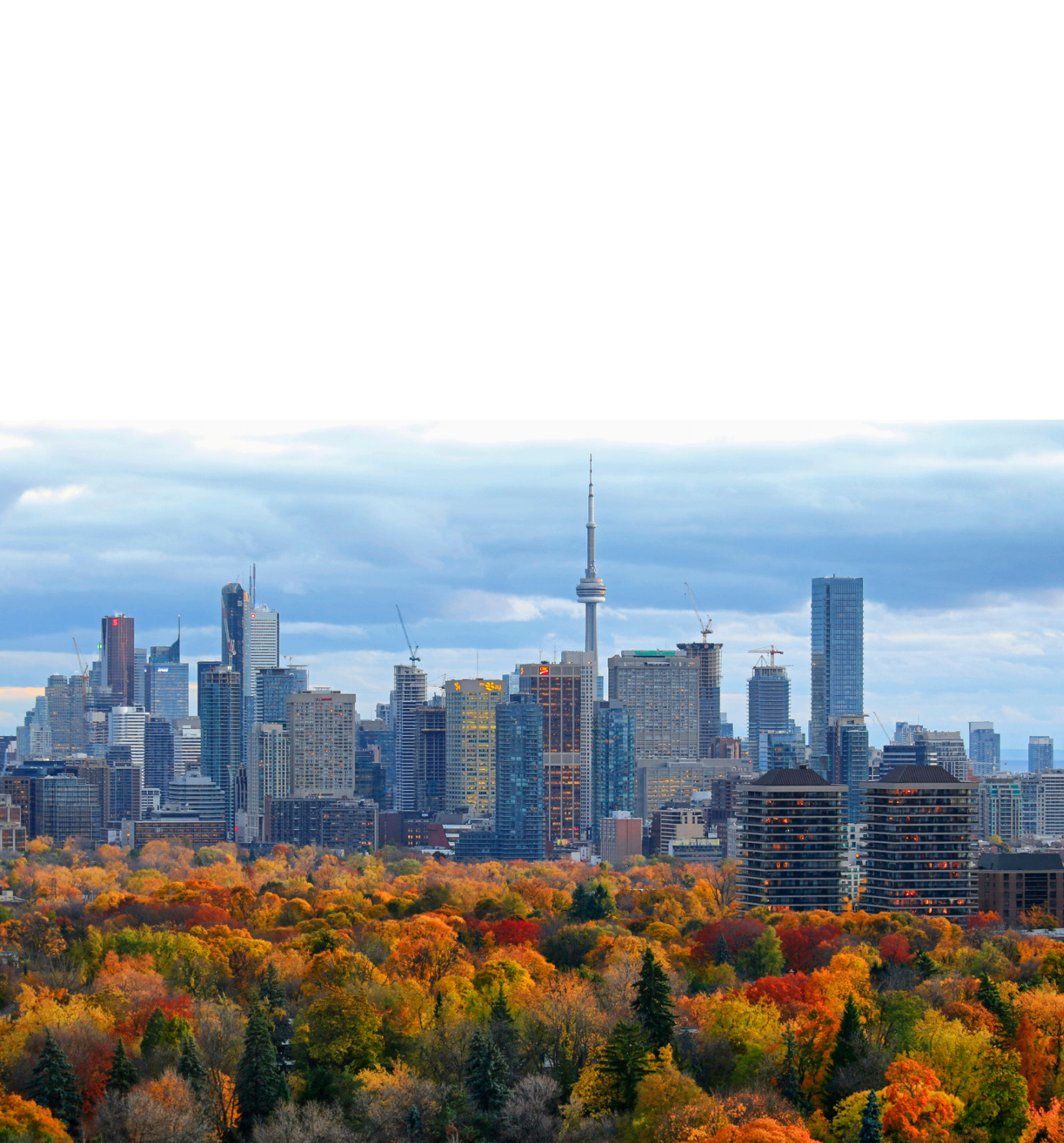 Toronto skyline over fall foliage, representing Link Influence's roots as a social media agency since 2018, focused on authentic, human conversations and brand storytelling.