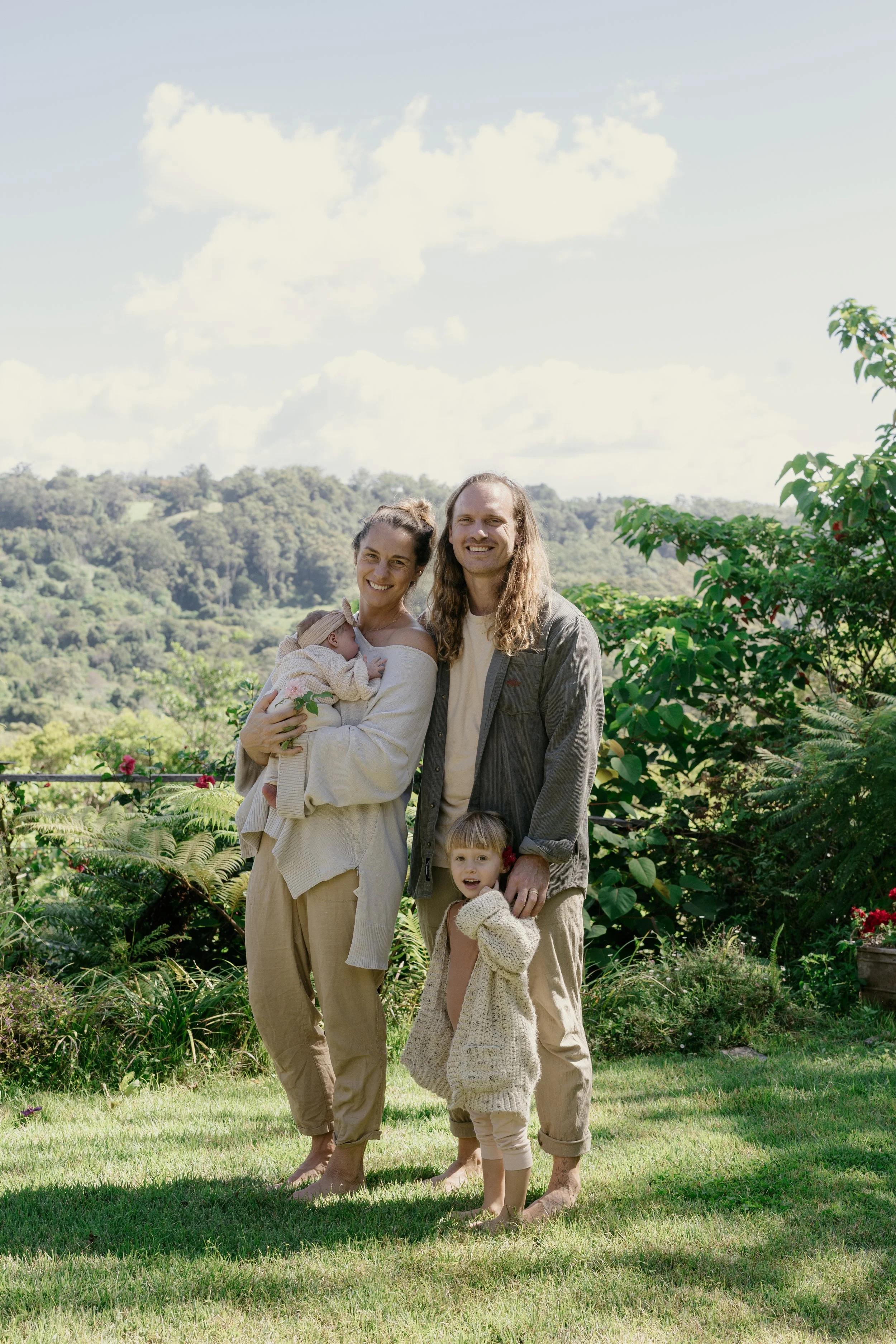 Michael and Britney, the Gather & Co founders, standing together outdoors in a garden with rolling green hills in the background.