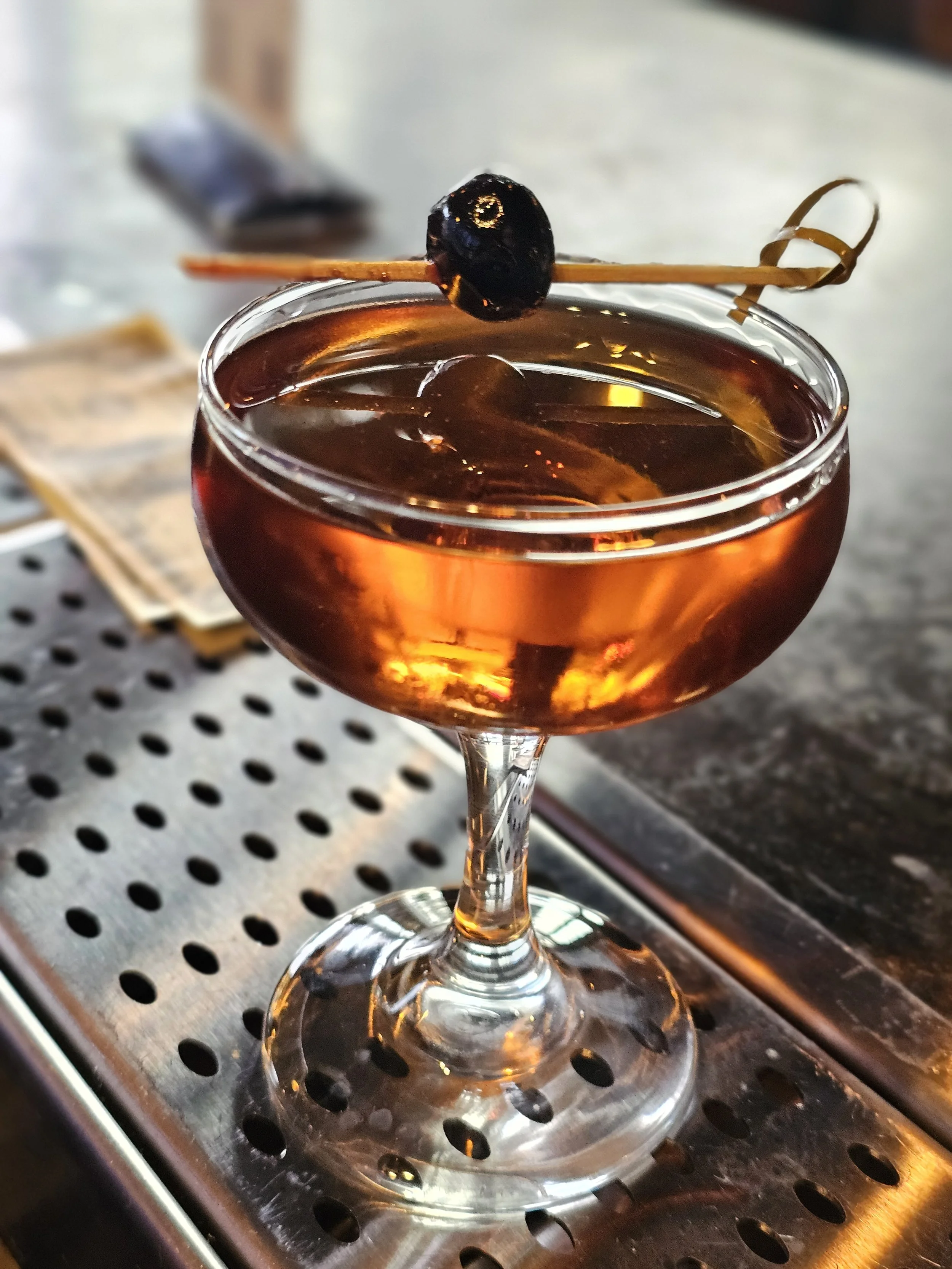 Manhattan.
A classic, spirit-forward cocktail that is rich, smooth, and slightly sweet. It blends whiskey with sweet vermouth and bitters, usually garnished with a cherry. Elegant and warming, it’s known for its silky texture and deep, layered flavor