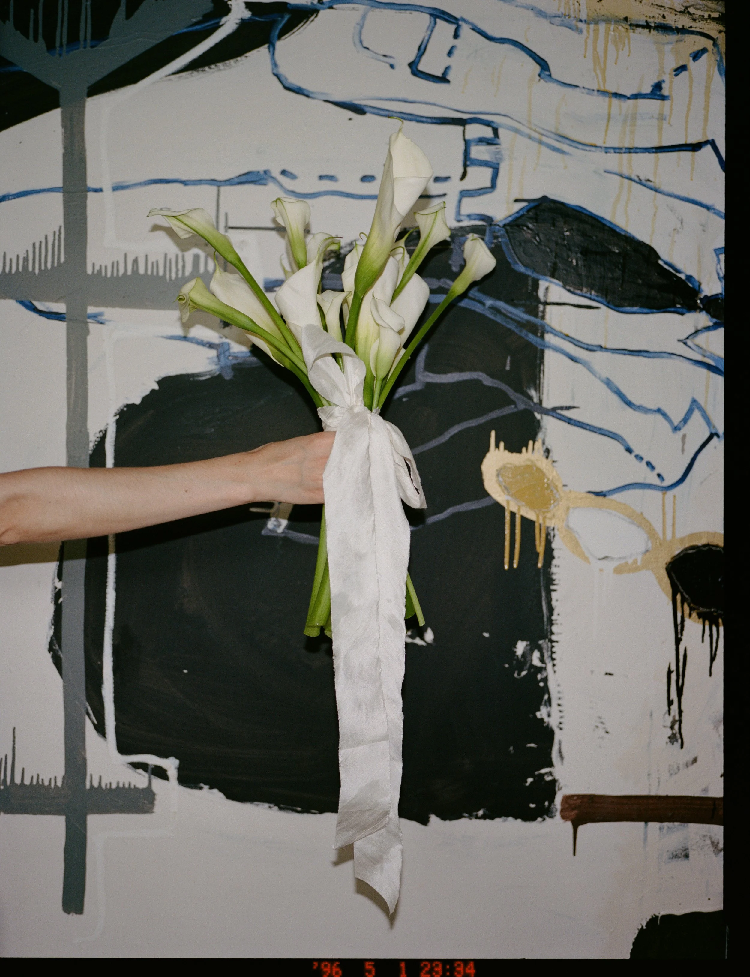Bride holding a bouquet at Chicago intimate wedding at Charcoal Factory Loft