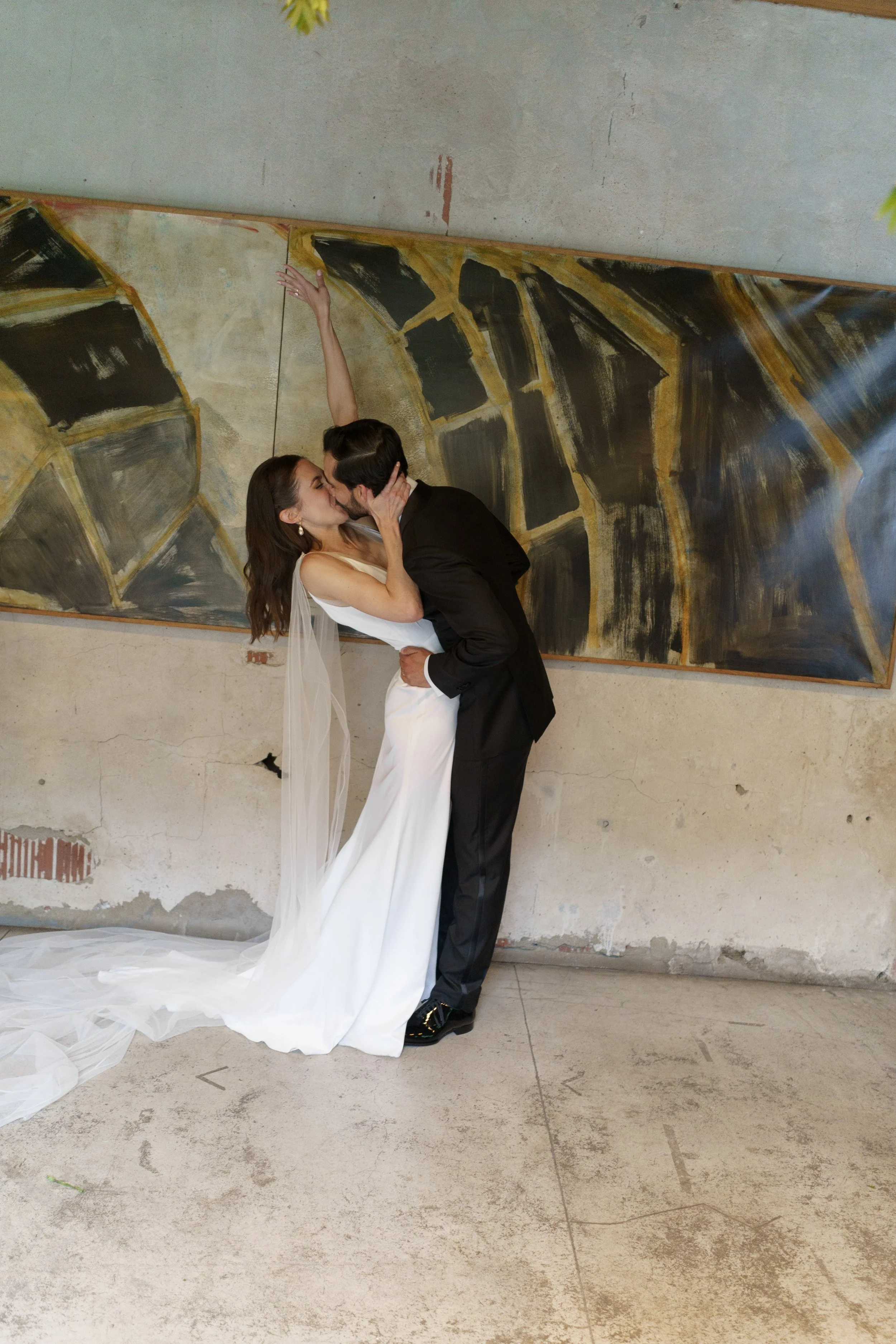 Wedding couple first kiss at Charcoal Factory Loft intimate wedding venue