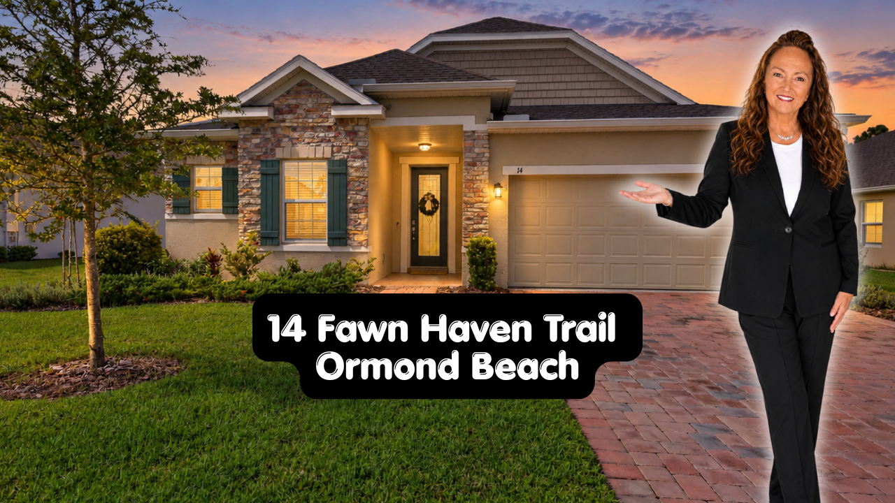 A woman in a black suit standing in front of a house at sunset, with a sign that reads '14 Fawn Haven Trail Ormond Beach' in front of her.
