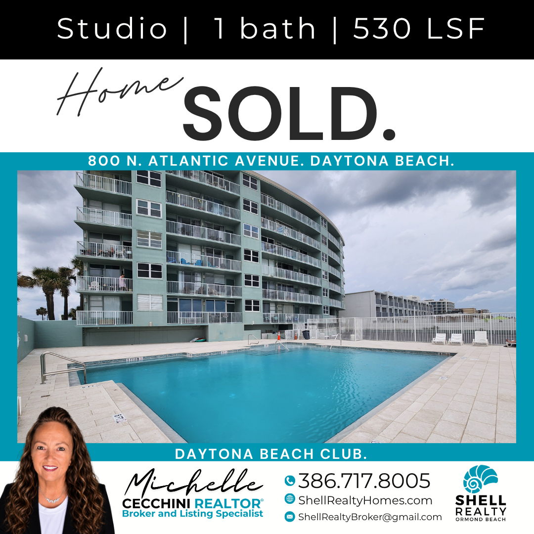 Real estate sold sign for a one-bedroom studio apartment at 800 N. Atlantic Avenue, Daytona Beach, showing a building with balconies and a swimming pool outside.