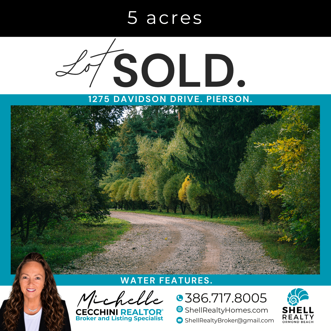 Real estate listing sign indicating 5 acres of land on Davidson Drive in Pierson, recently sold, features a dirt road surrounded by green trees and shrubs, includes contact info for real estate agent Michelle Cecchini, Shell Realty, Ormond Beach.