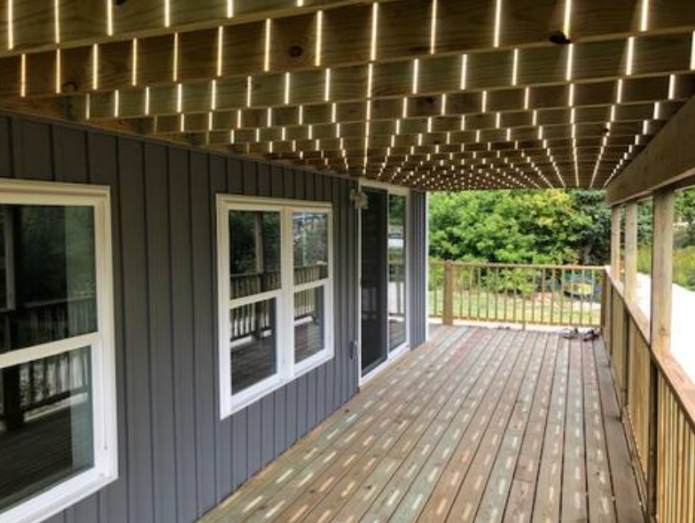 Sliding glass doors opening to waterfront deck in Gordon’s Ledge