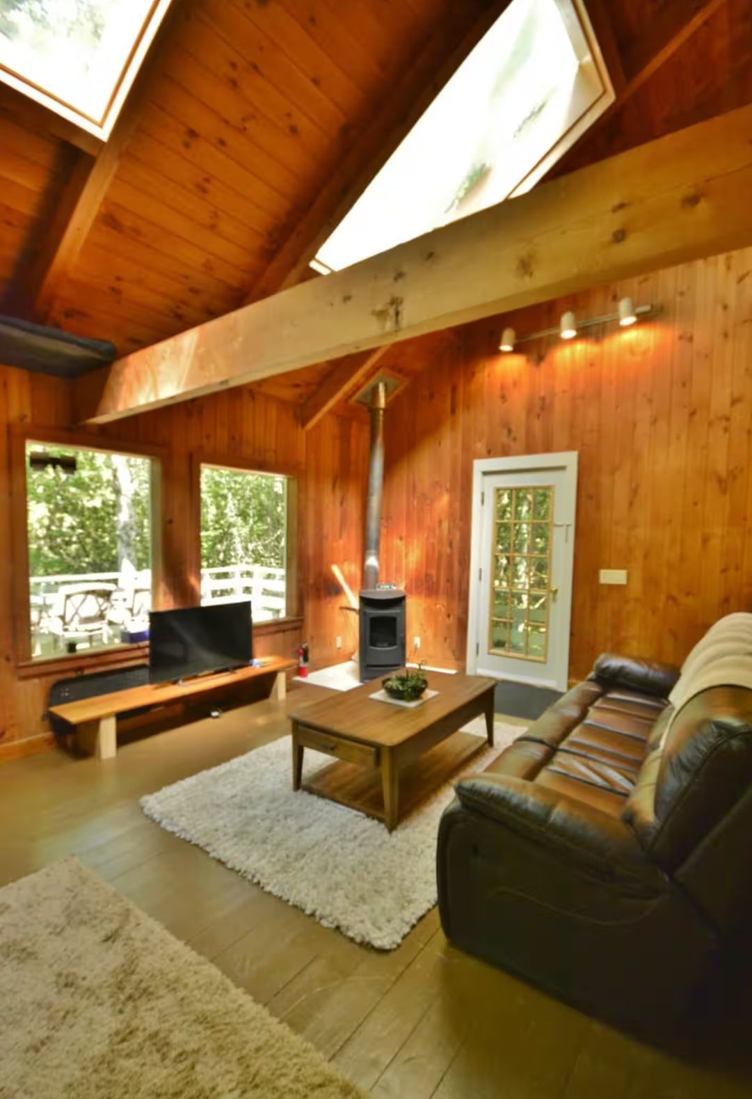 Wood stove and seating area inside Rocky Brook Cottage