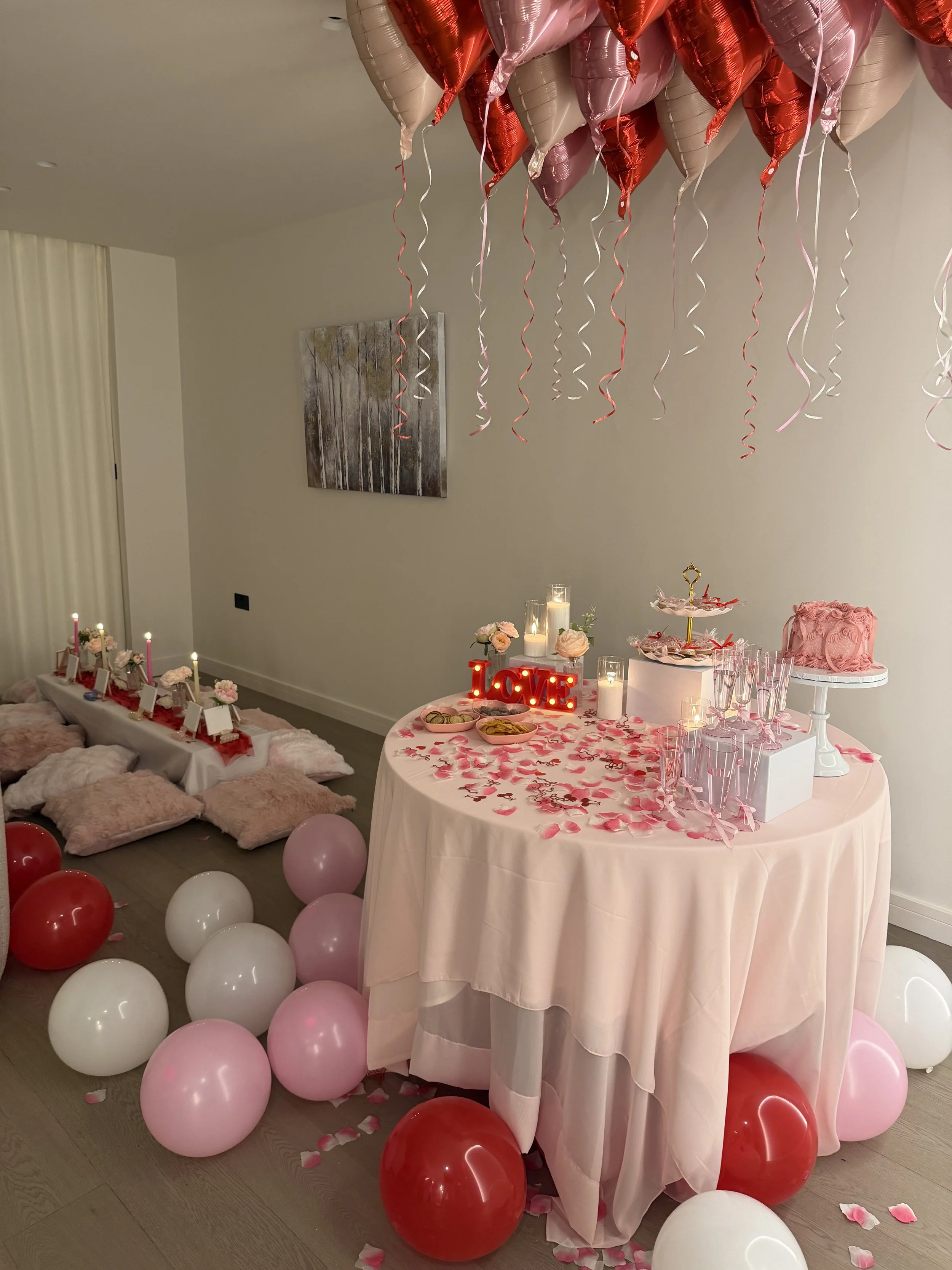 setup with balloons, petals, pillows and sip and paint setup