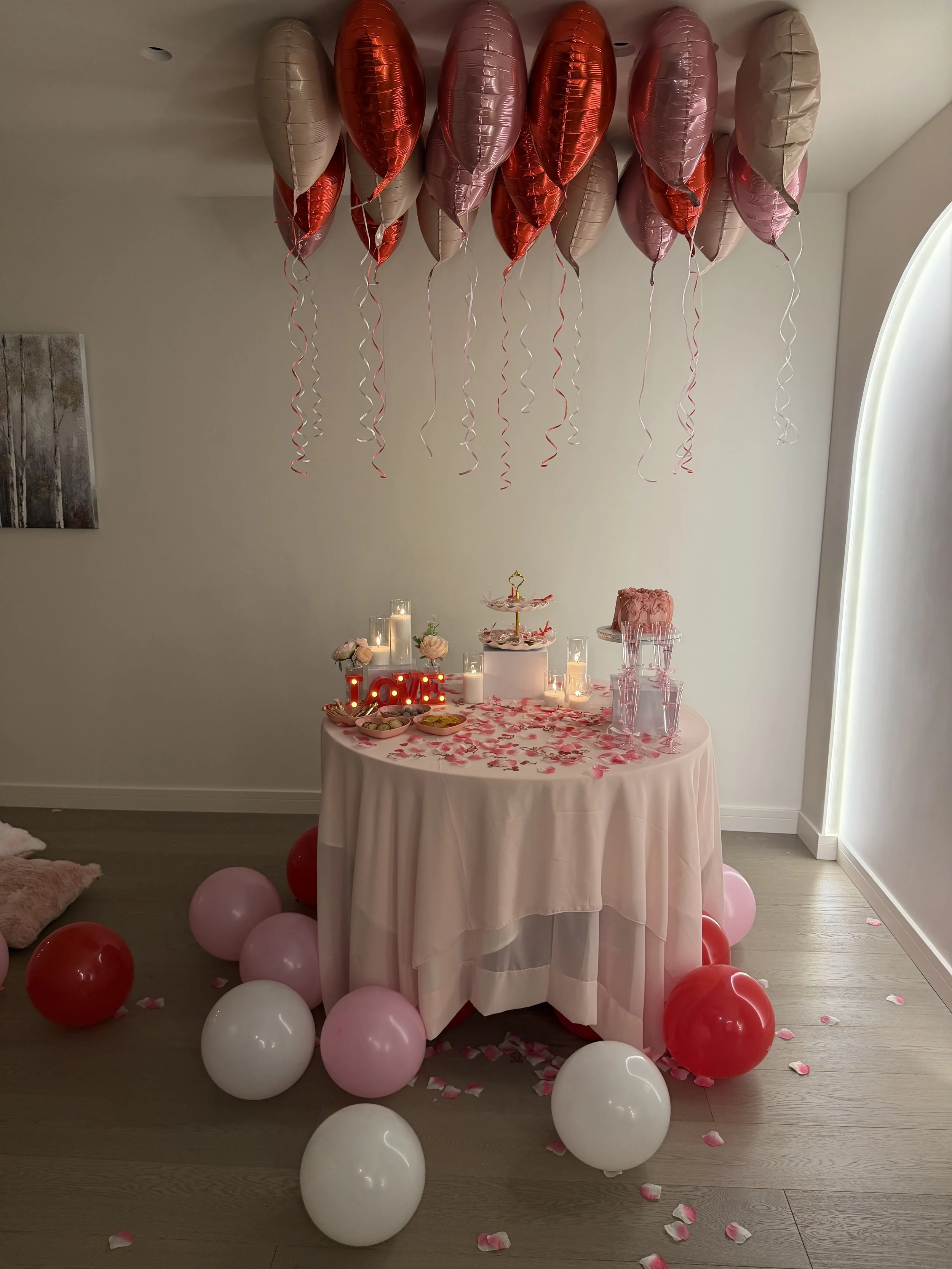table setup with candles, flowers, balloon