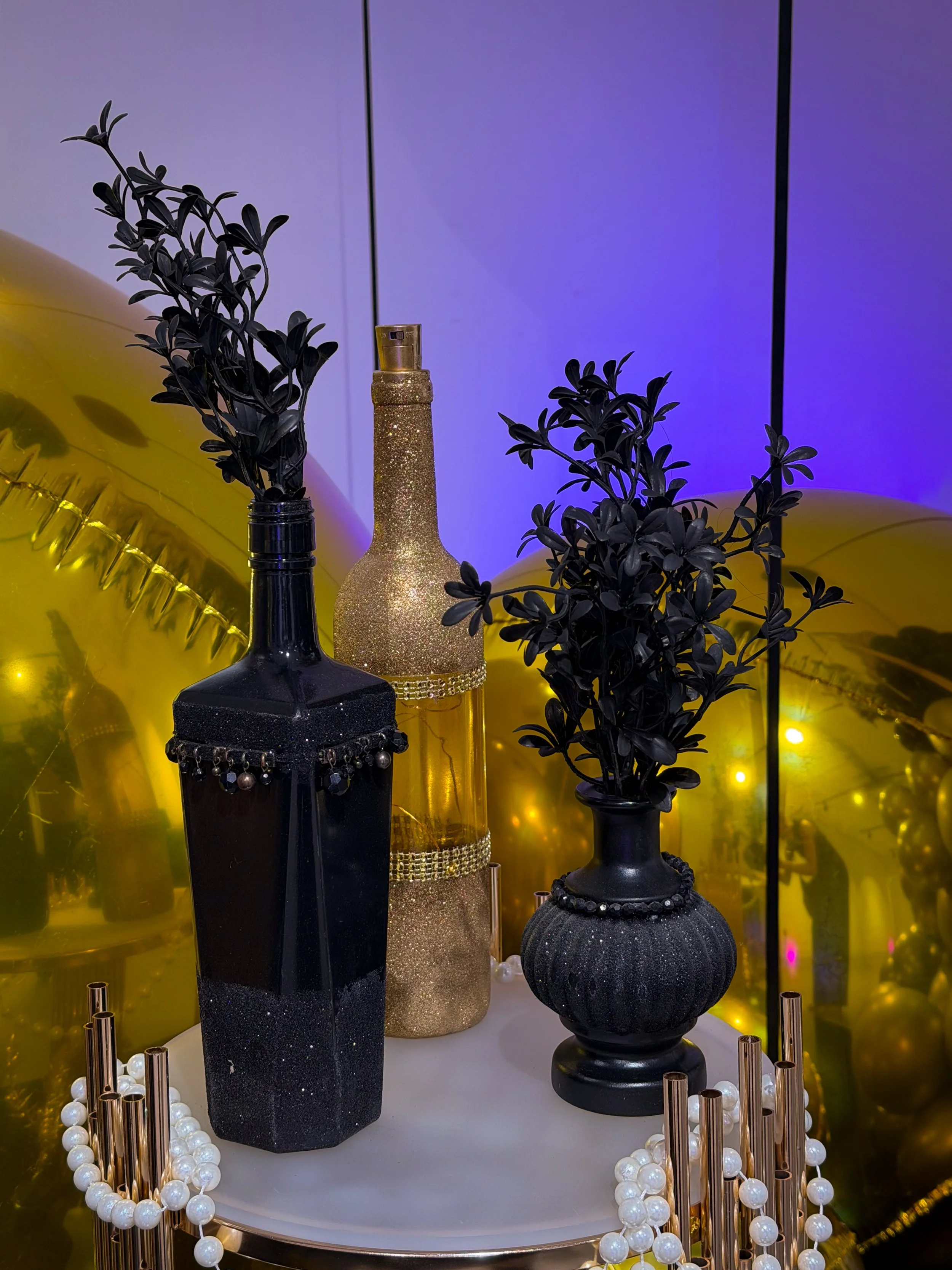 gold and black vases with flowers