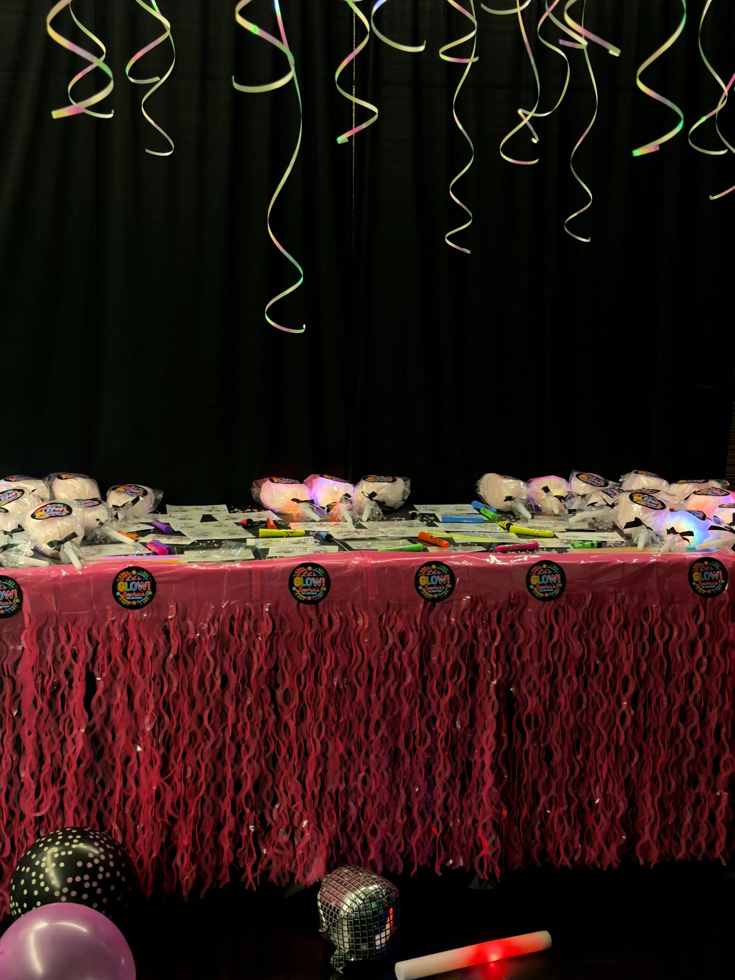 table with face gems and candyfloss, and let's glow stickers