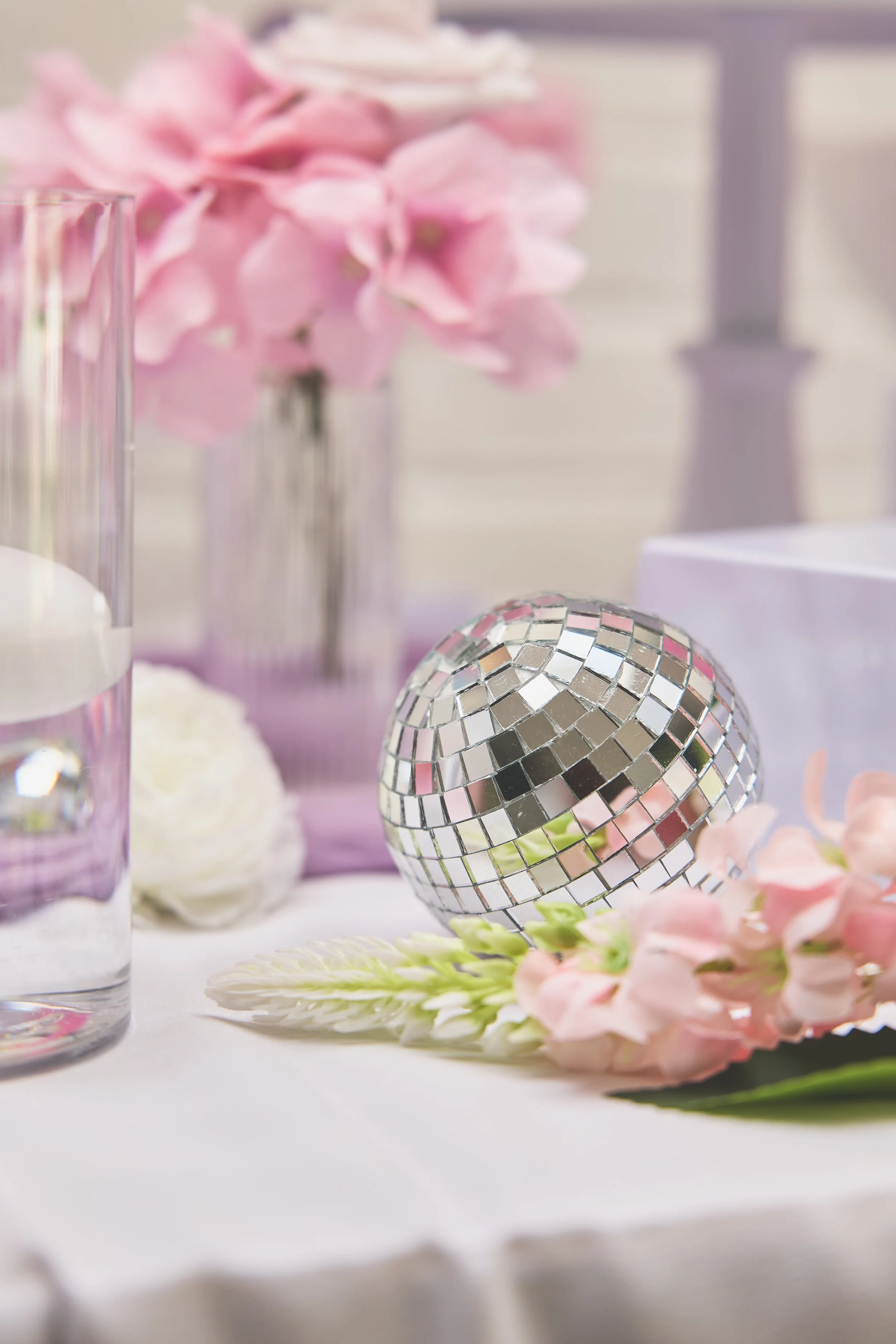disco ball and floating candle in vase filled with water