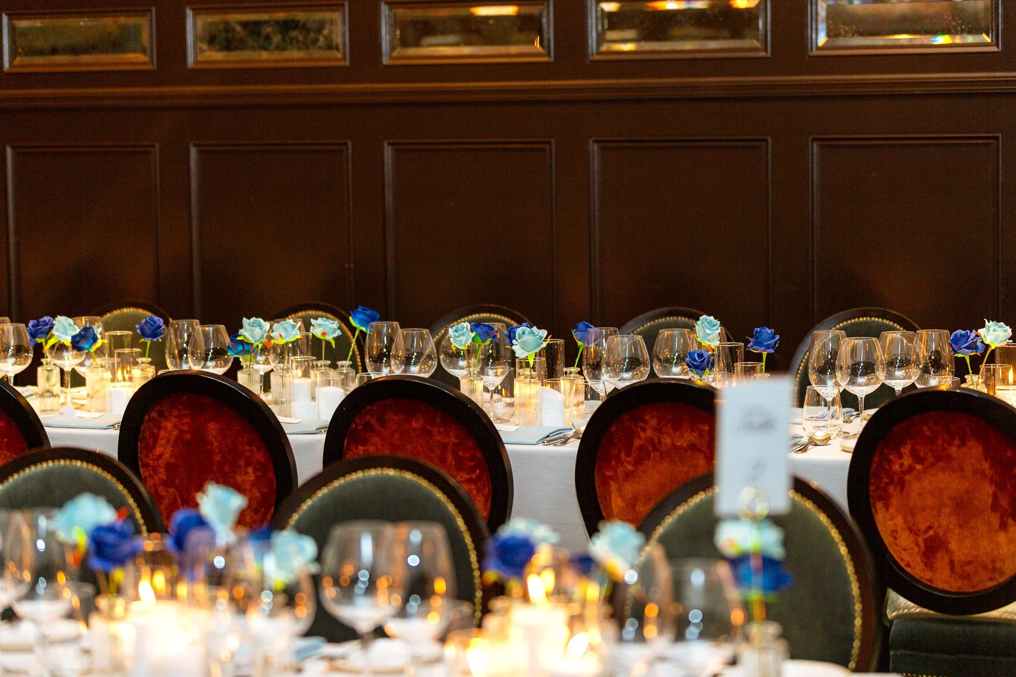 wedding reception table decor with flowers and candles and glasses
