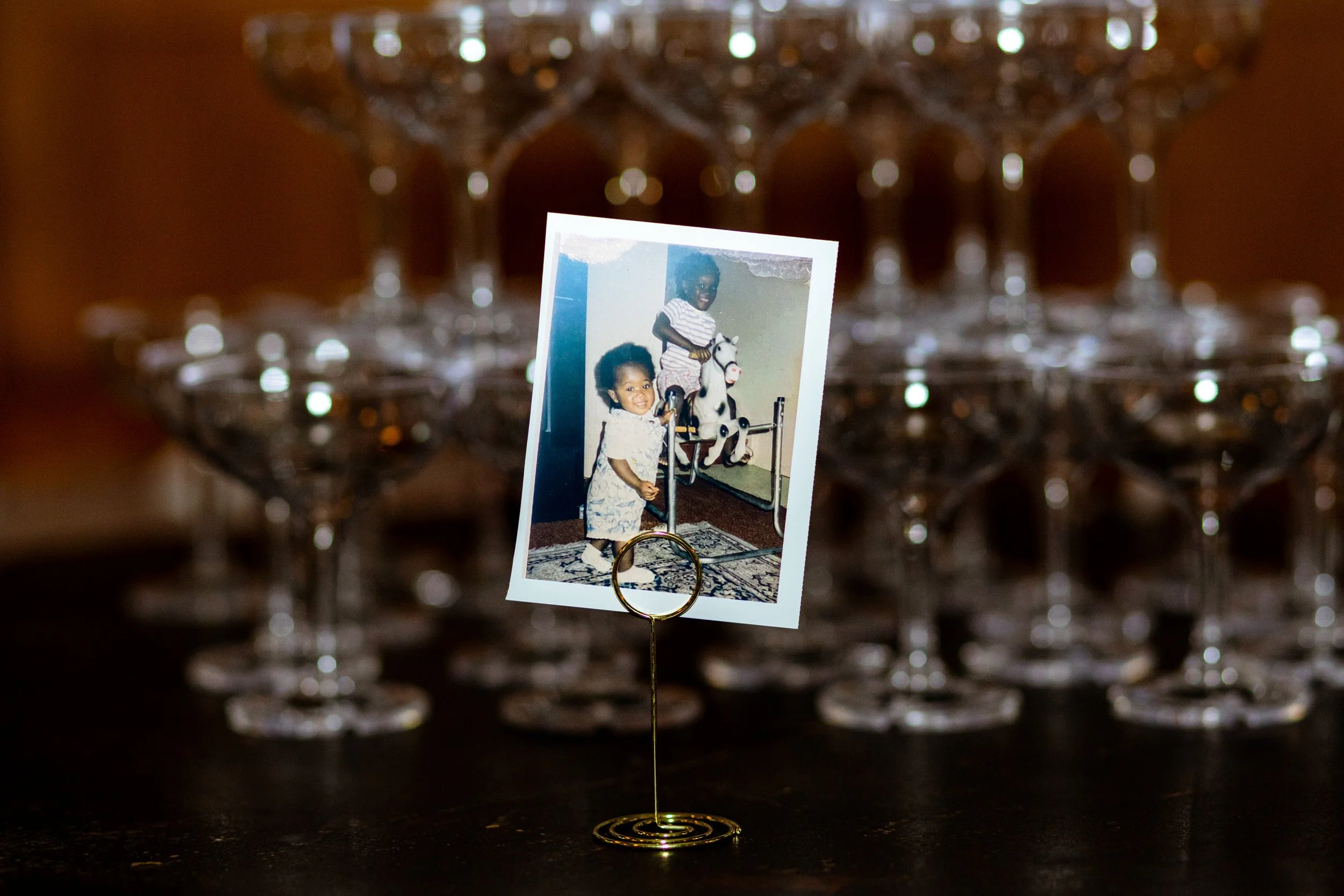 baby picture of celebrant in front of champagne tower