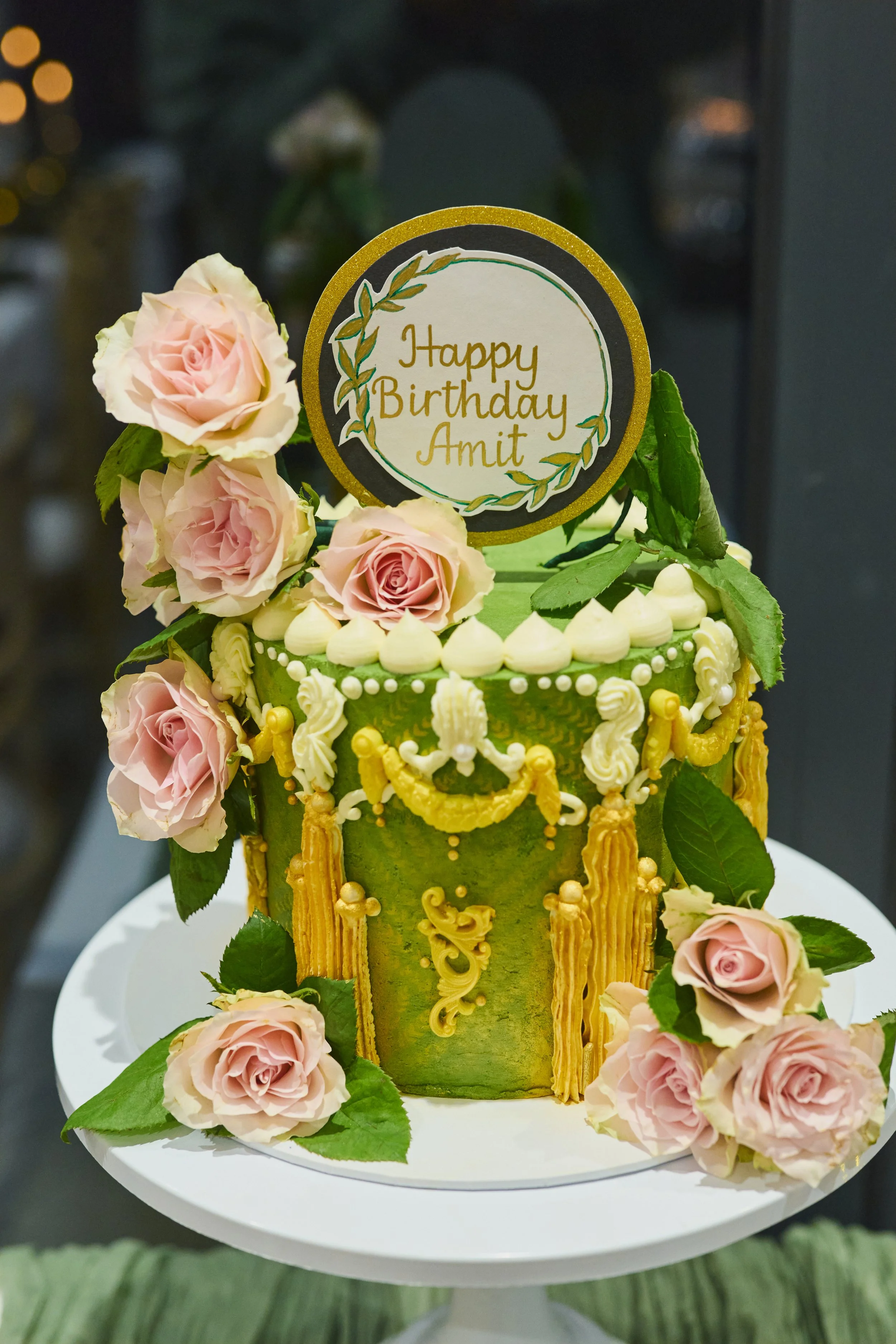 cake with green and gold and flowers
