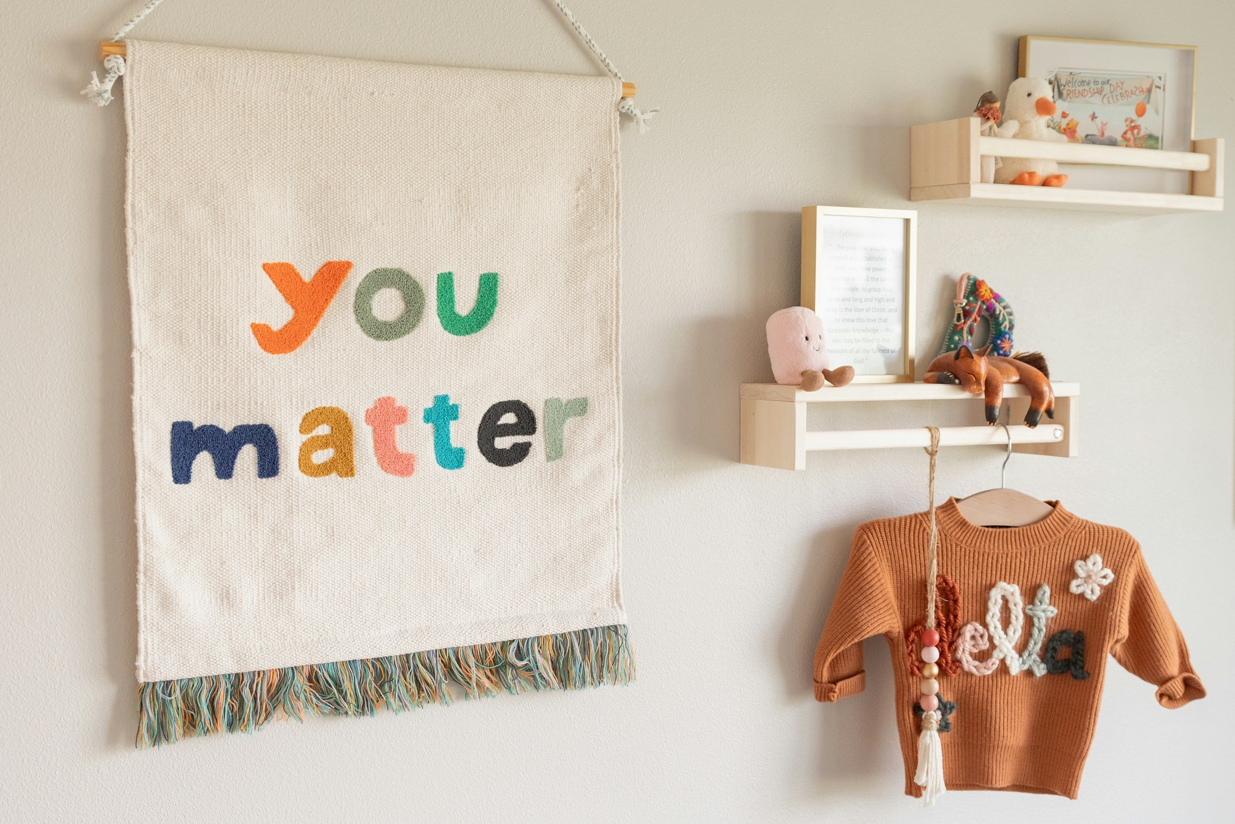 Neurodiversity-affirming pediatric speech therapy environment with cozy child-friendly decor and a "you matter" banner.