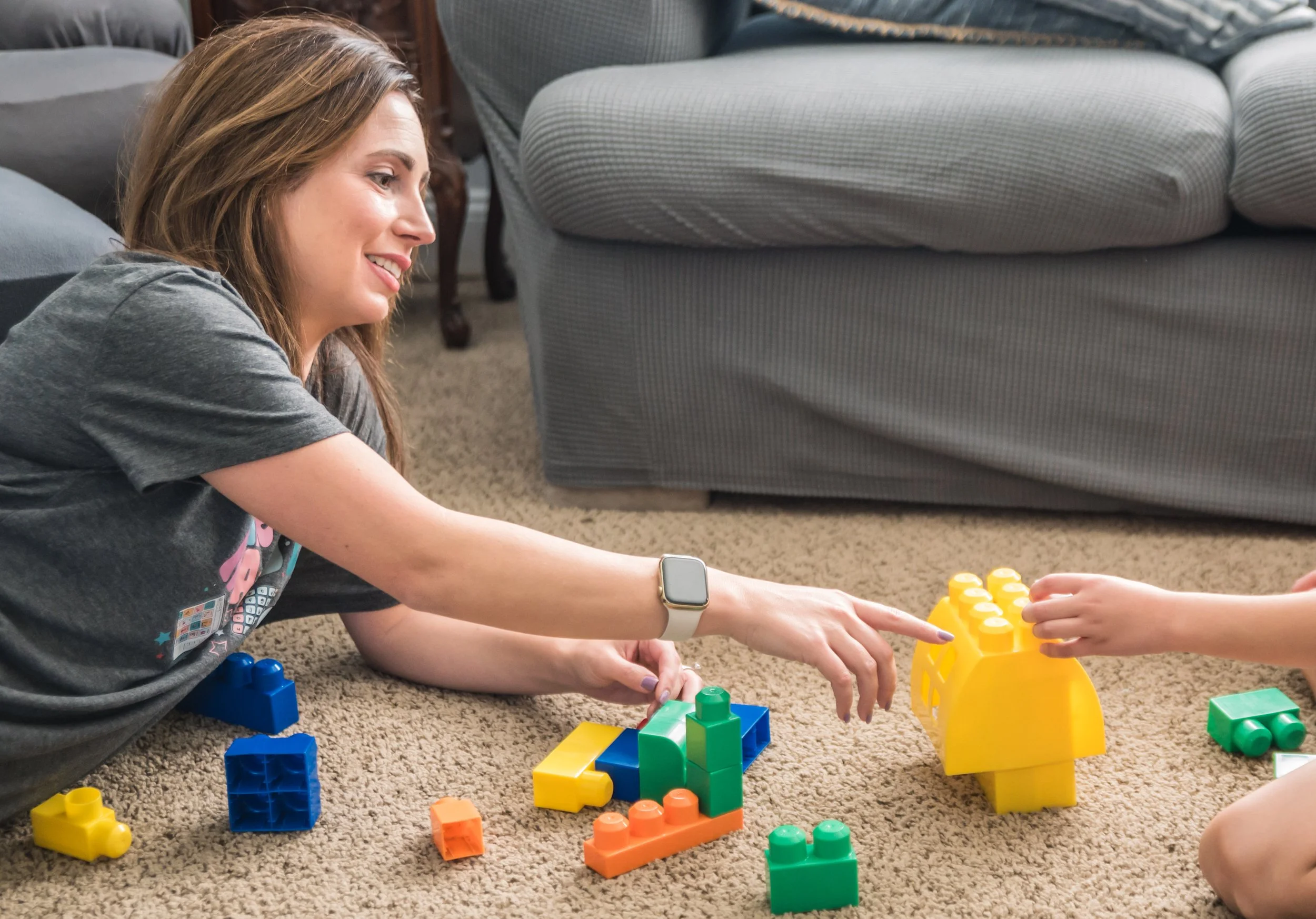 Play-based pediatric speech therapy session in home setting, supporting communication development through meaningful play and caregiver connection.