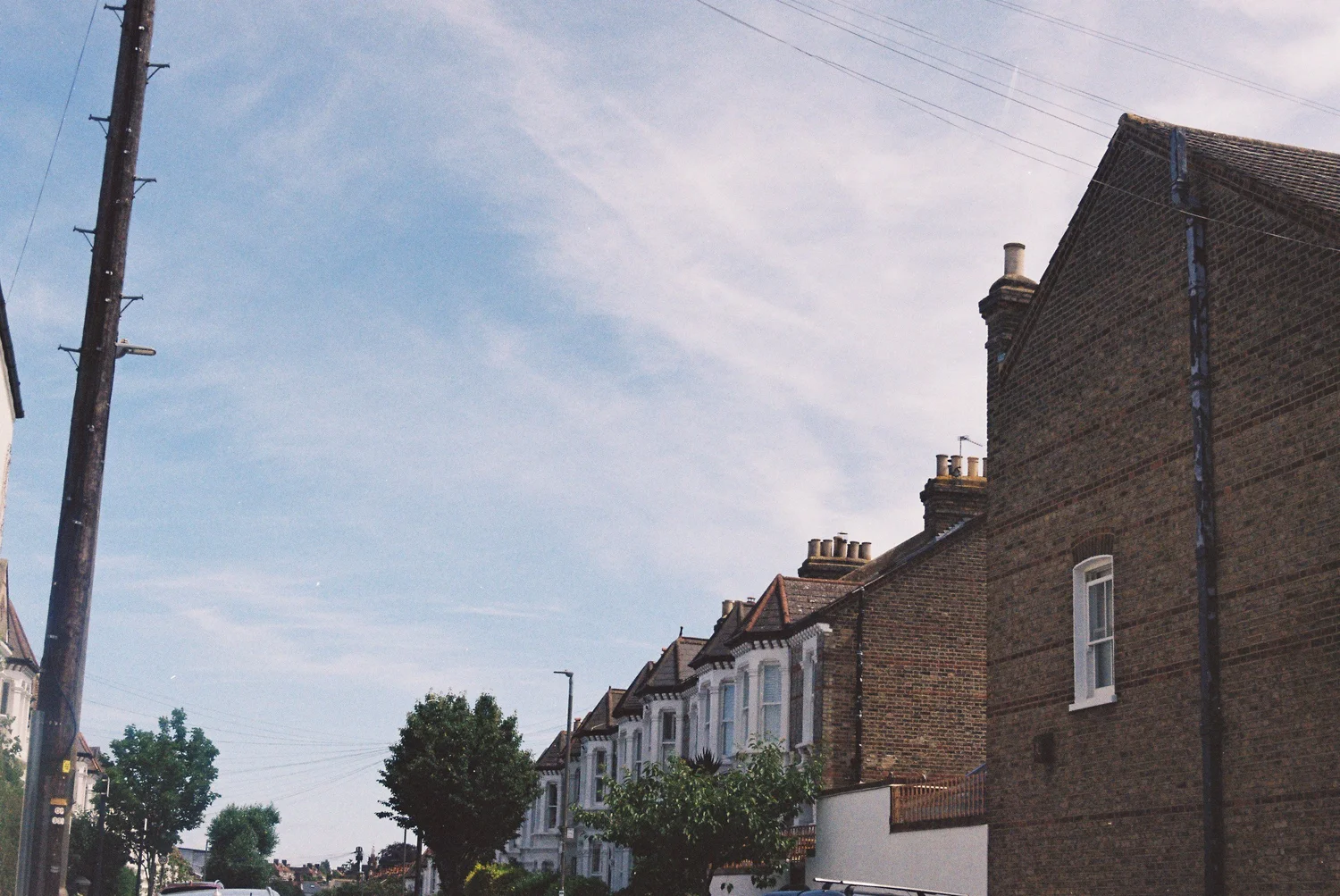 Brick terraced houses beneath a wide sky on a residential street in Richmond upon Thames