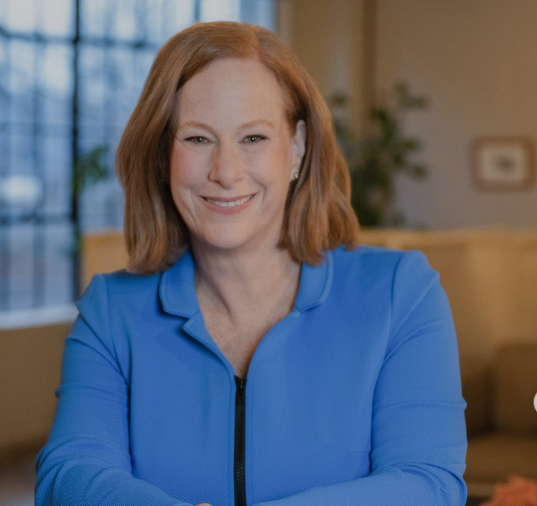 Author Allison Gilbert smiling wearing a blue jacket