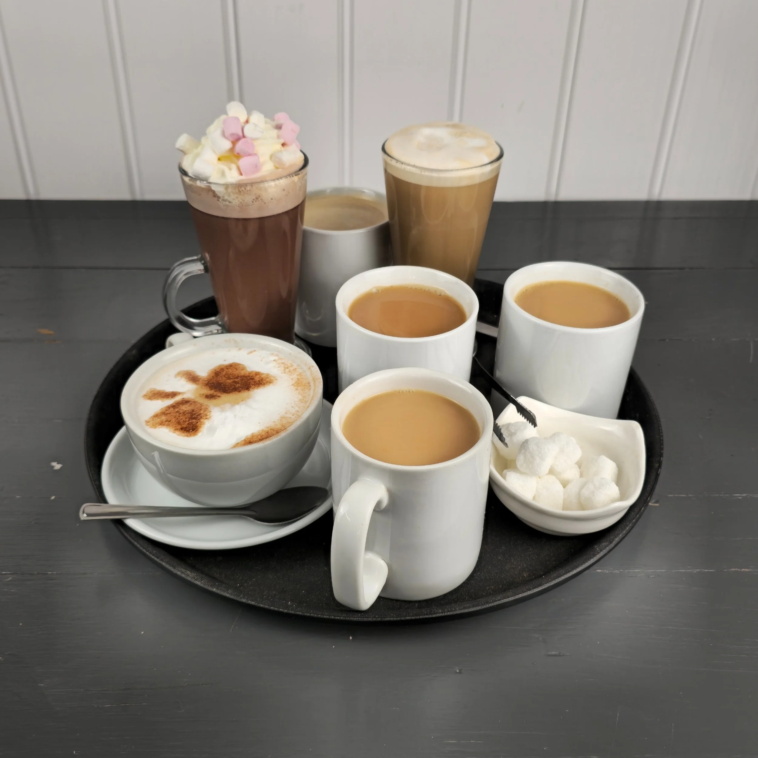 A range of freshly prepared hot drinks including cappuccinos, lattes, teas and a deluxe hot chocolate with marshmallows. This image is perfect for showcasing Silverwood Café’s warm drink selection and promoting cosy, café-style relaxation.