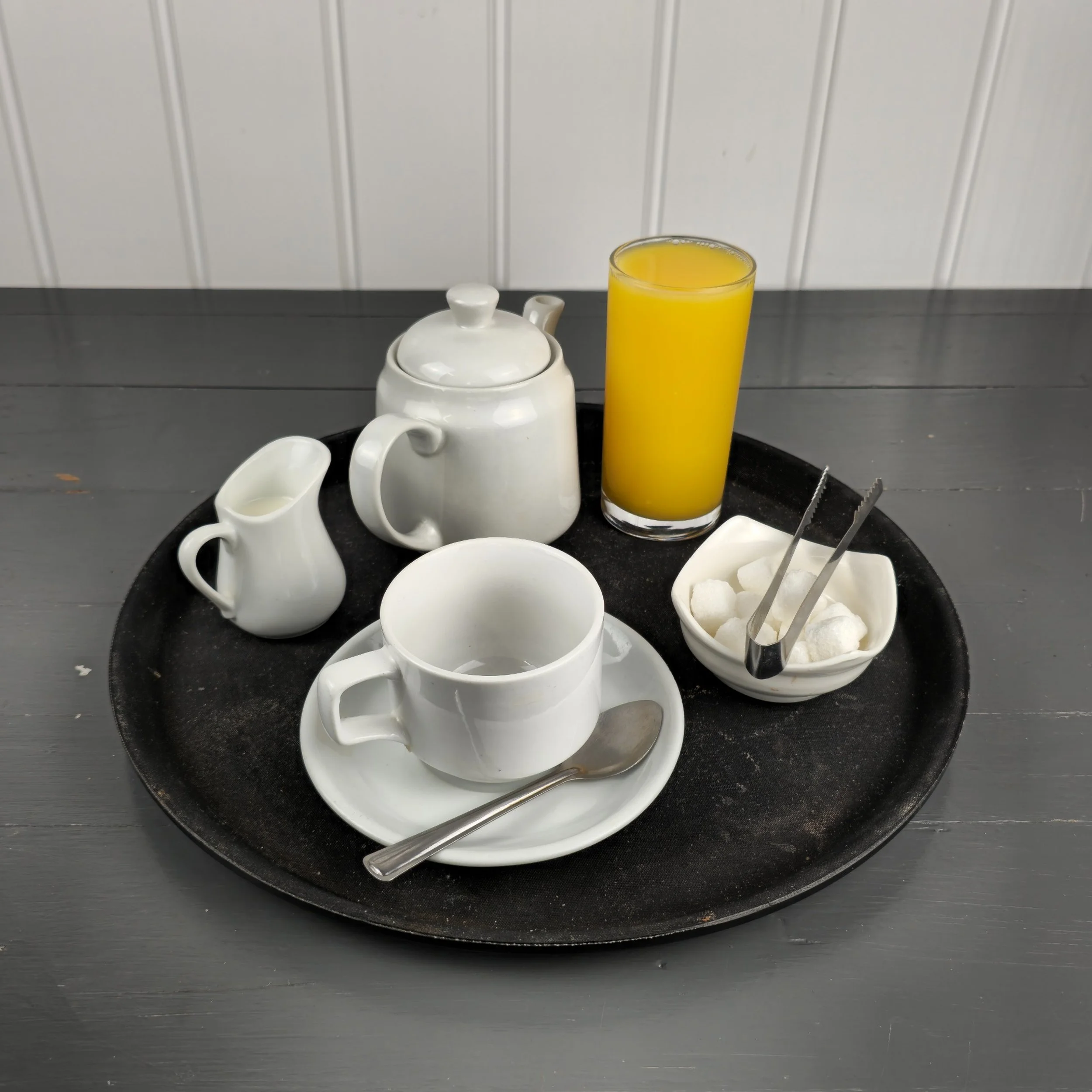 A clean and inviting presentation of Silverwood Café’s classic tea service, complete with fresh orange juice and sugar cubes. This image highlights the café’s attention to detail and its relaxed British tearoom style—perfect for marketing morning ser