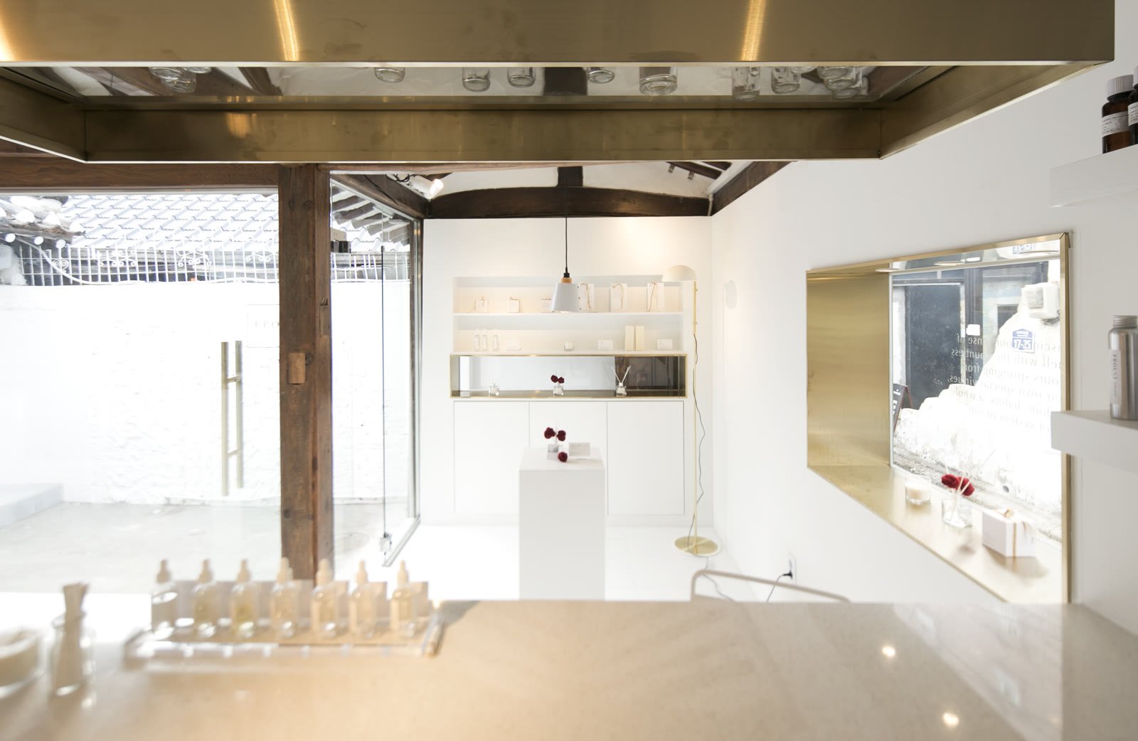 White wall with a brass-framed display window