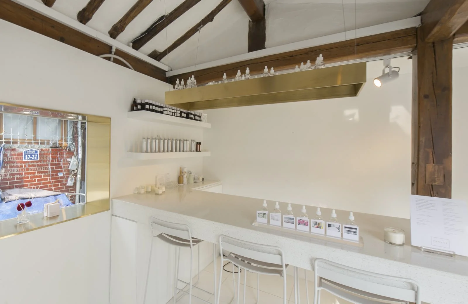White counter and shelves with brass details