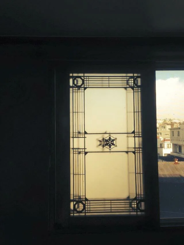 Original decorative glass window in an iron frame
