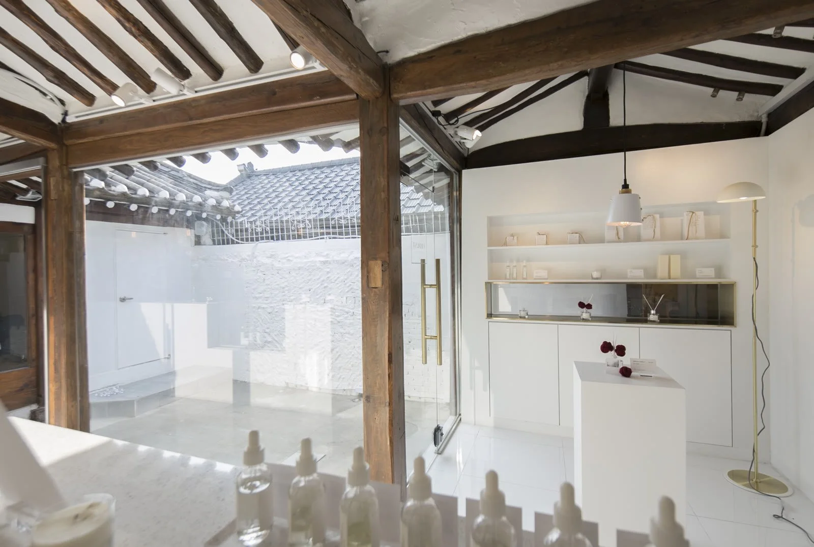 White interior under exposed hanok rafters