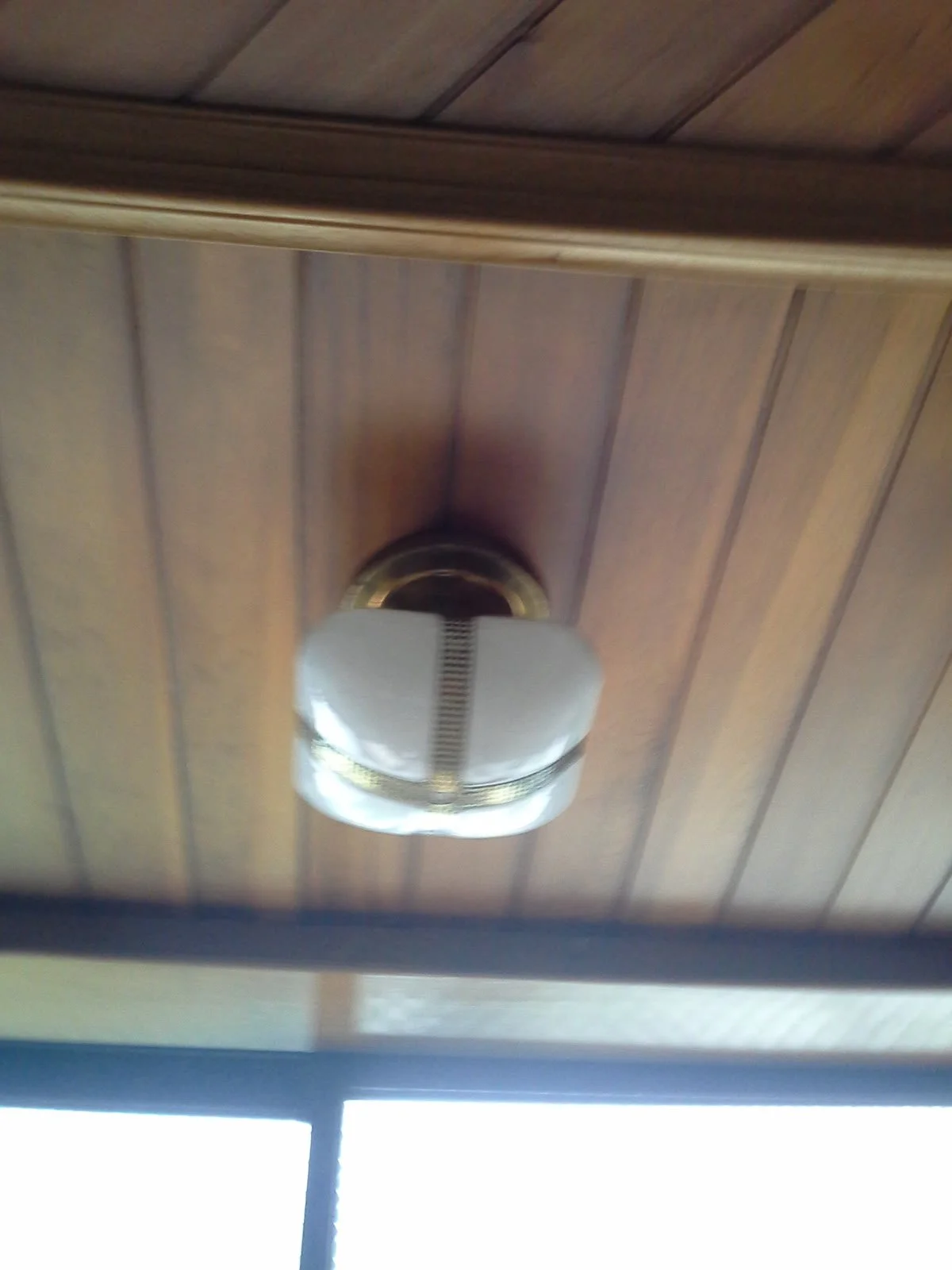 Original wooden ceiling with a vintage ceiling light