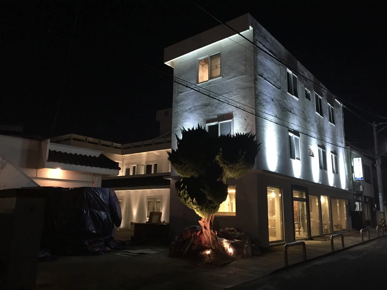 Mido Hostel exterior lit up at night