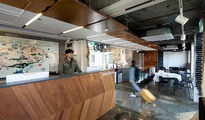 Mido Hostel lobby with the wooden reception counter