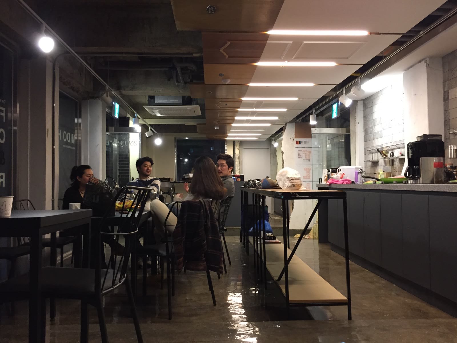 Guests at the long tables in the cafe at night
