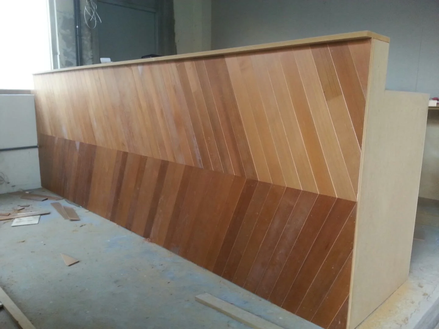 Reception counter front with a diagonal wood pattern