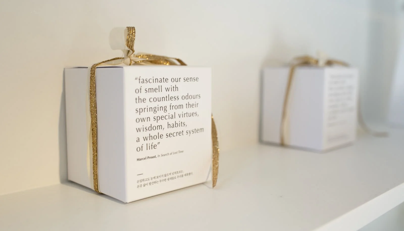 Proust gift boxes tied with gold ribbon