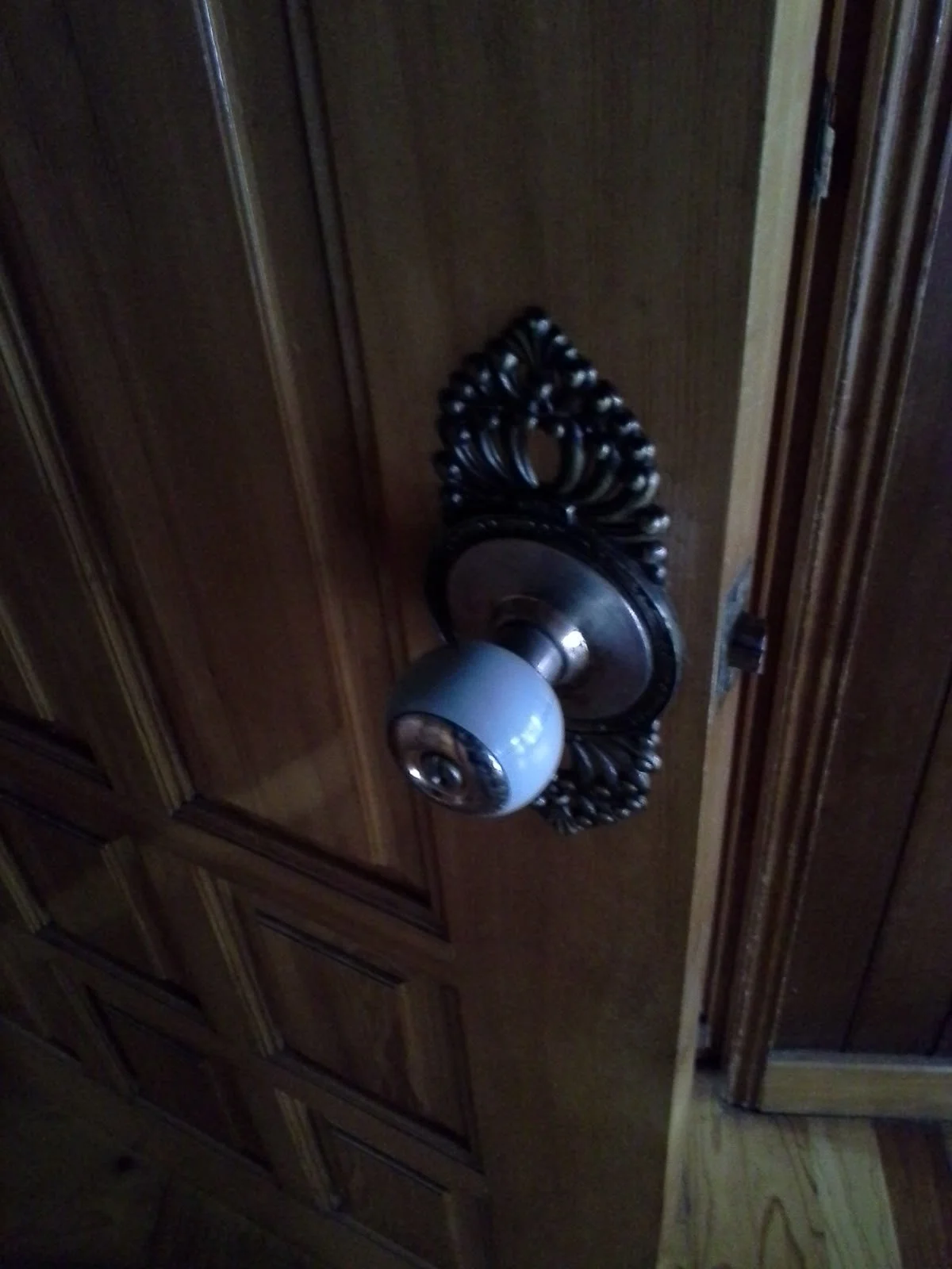 Original wooden door with an ornate doorknob